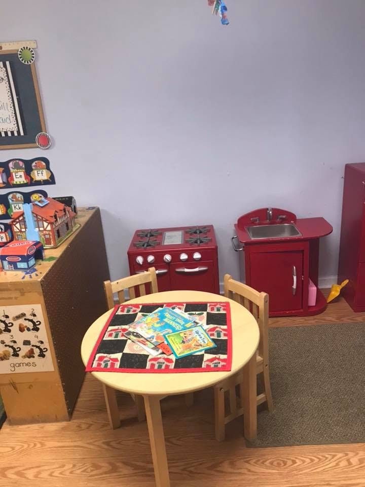Playroom with small table and chairs, toy kitchen appliances