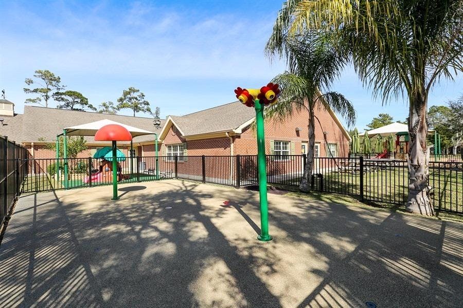 Outdoor playground with play structures and a fence