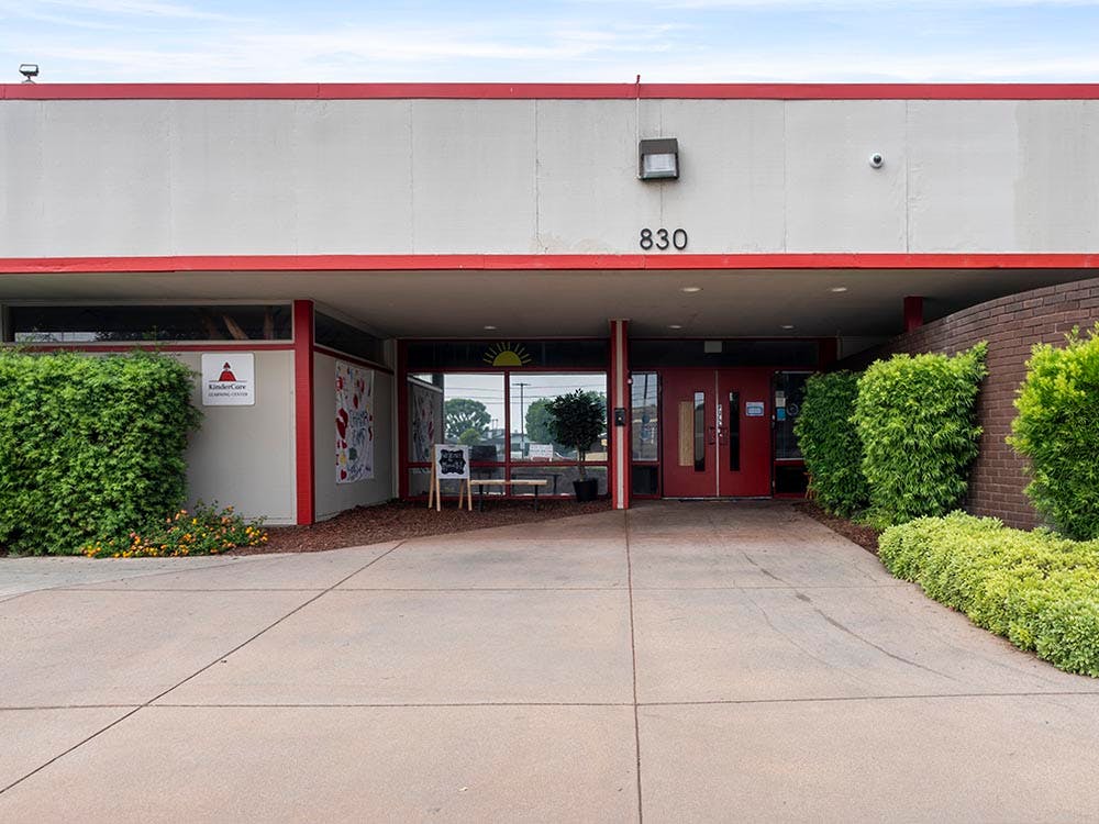 Entrance of a Kindercare Learning Center building with red doors