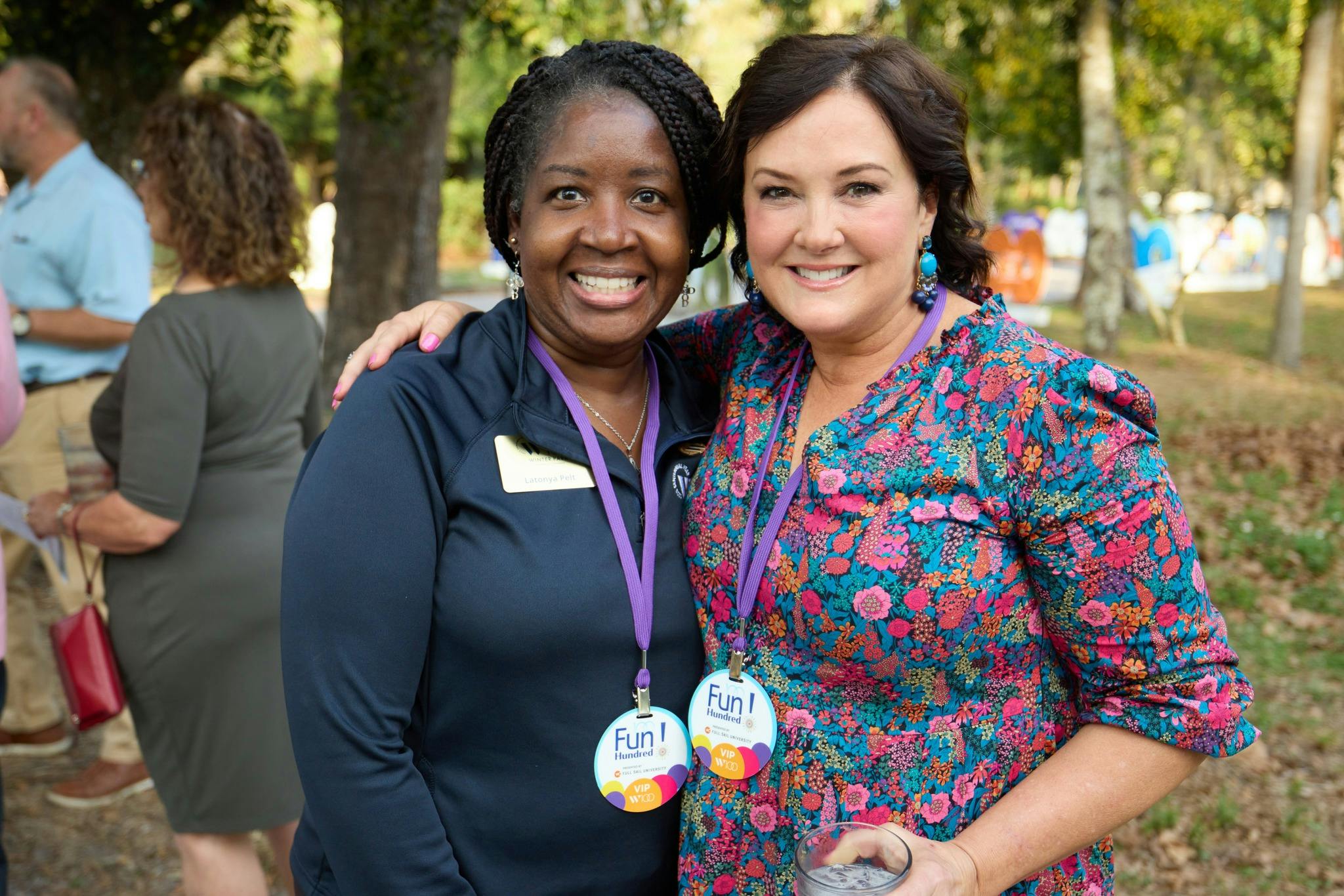 Two people with lanyards standing together