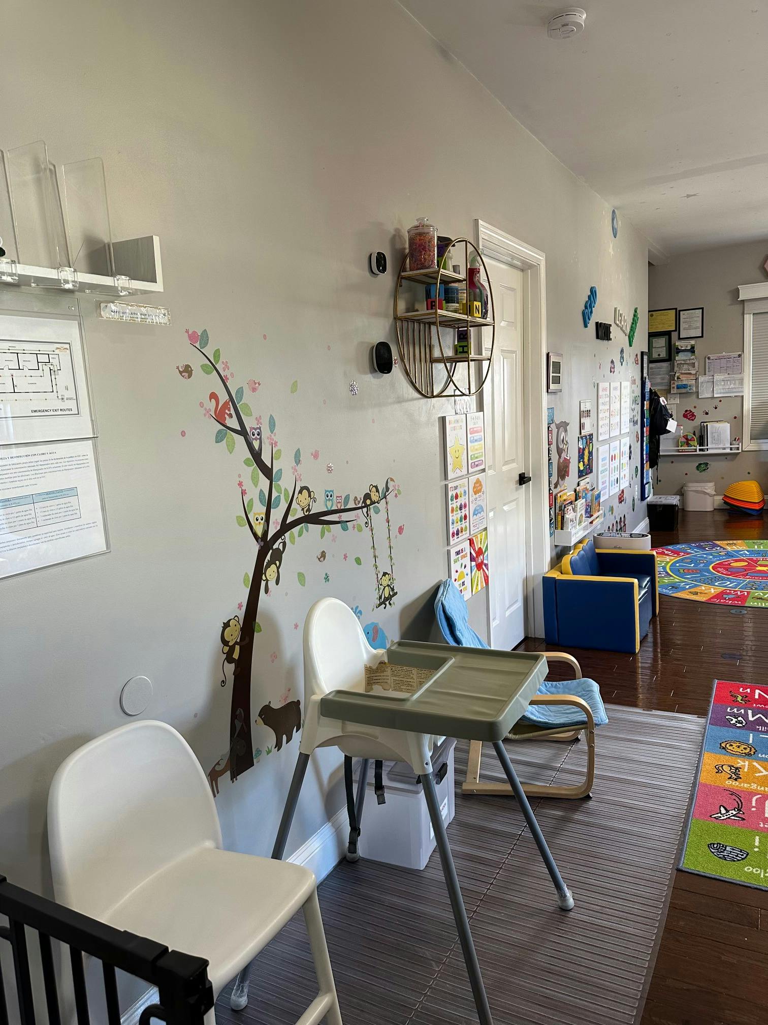 High chairs and small seating in a brightly decorated child care room