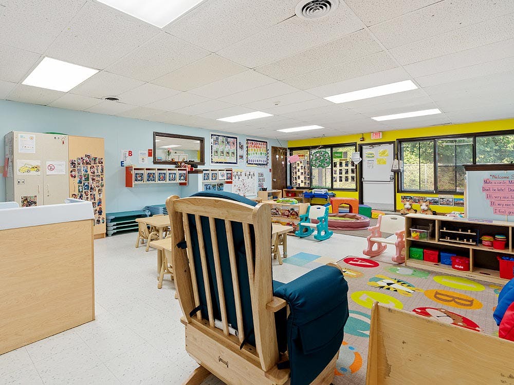 Classroom with child-sized furniture and a rocking chair in the foreground