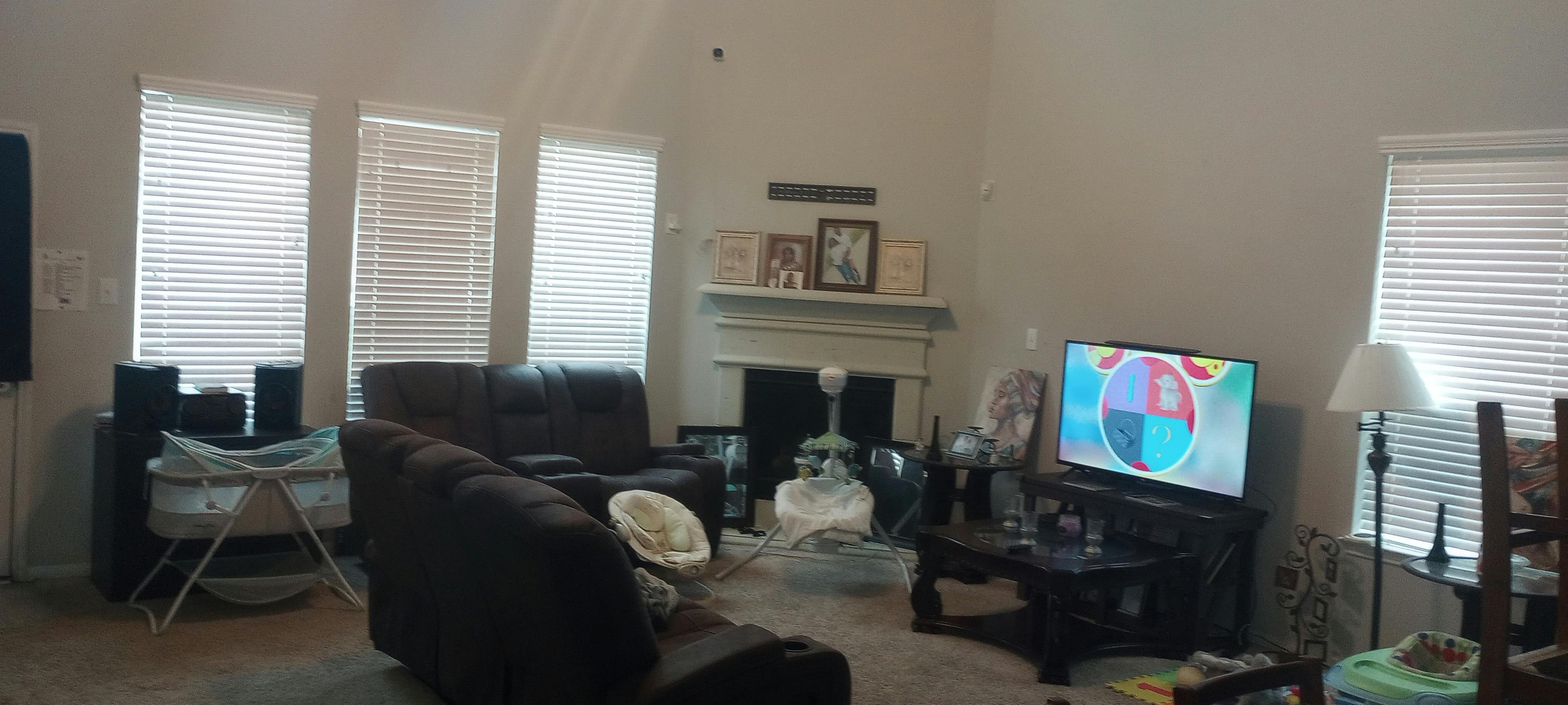 Living room with couches, television, and fireplace