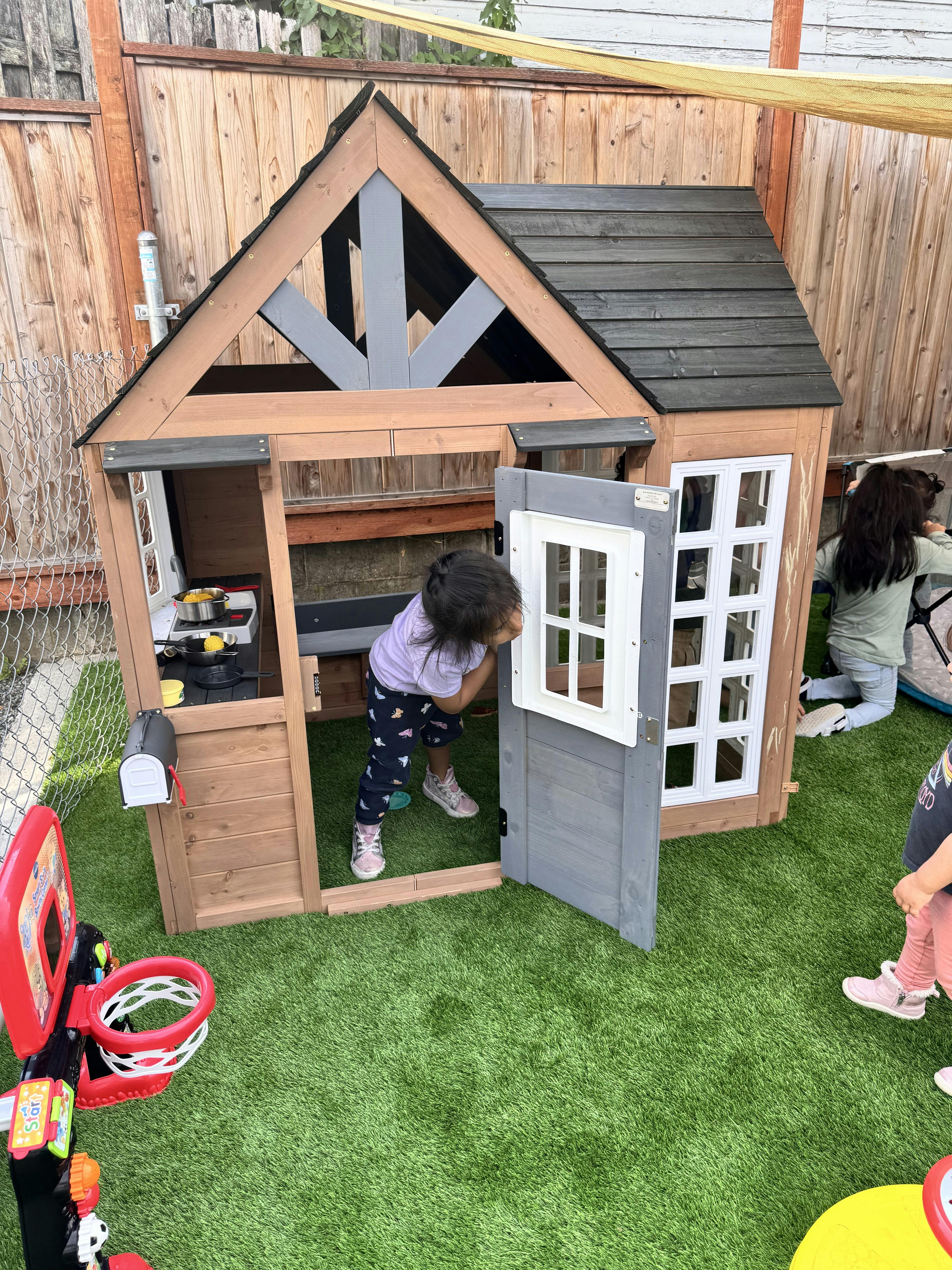 Child looking into a playhouse