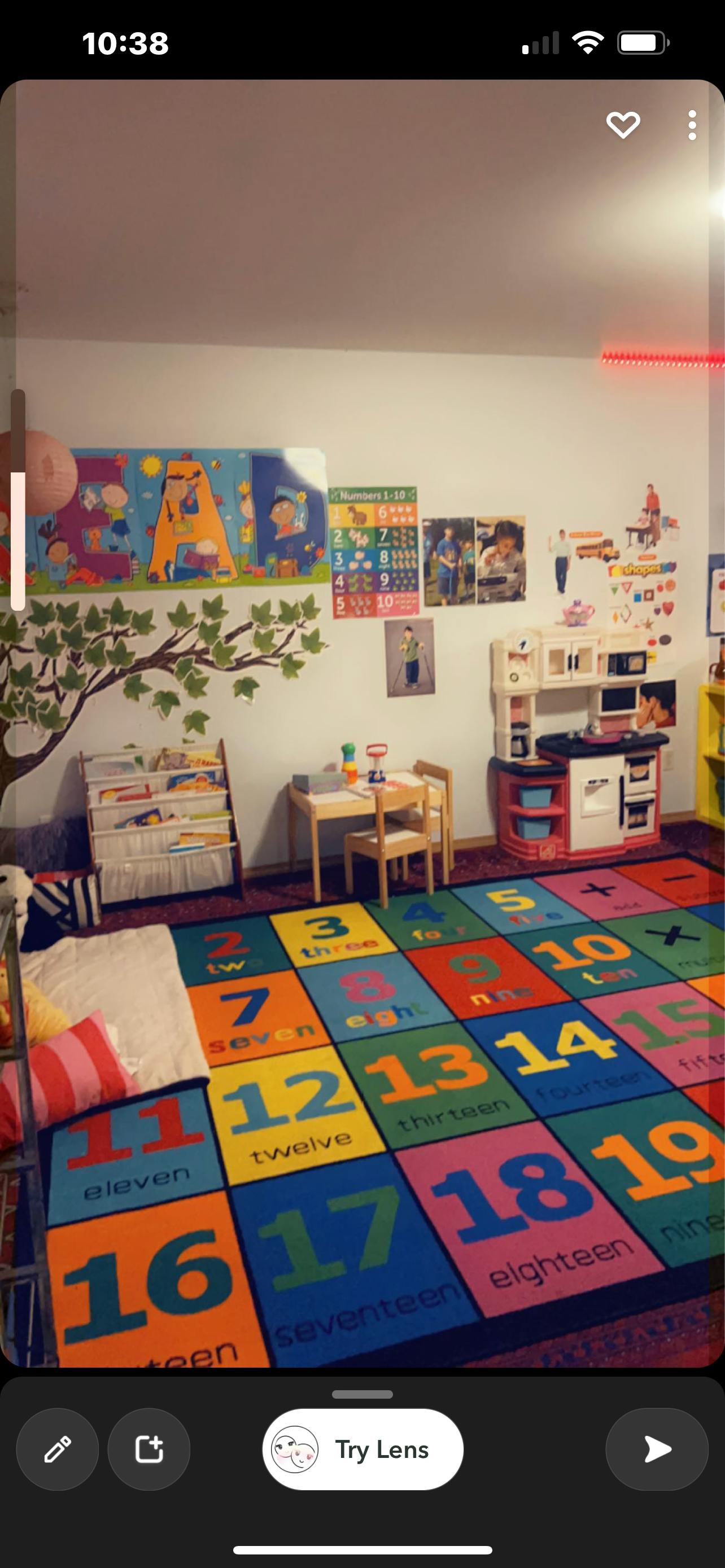 Playroom with a colorful number rug, small table and chairs, and toy kitchen