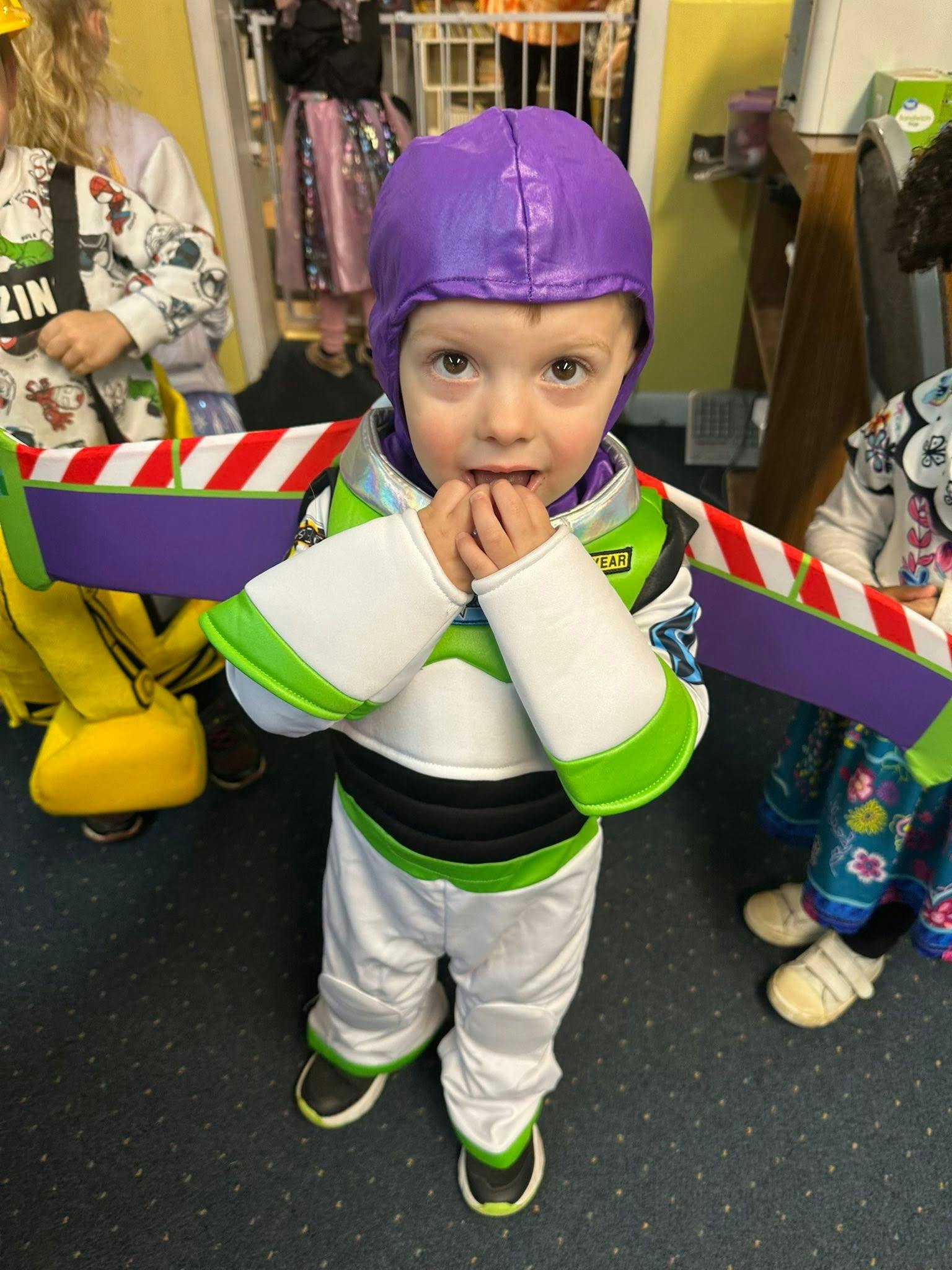 Child wearing a space ranger costume with wings