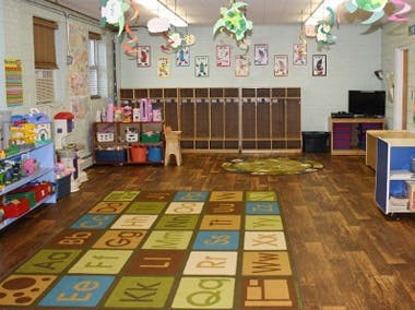 Playroom with alphabet rug and toys
