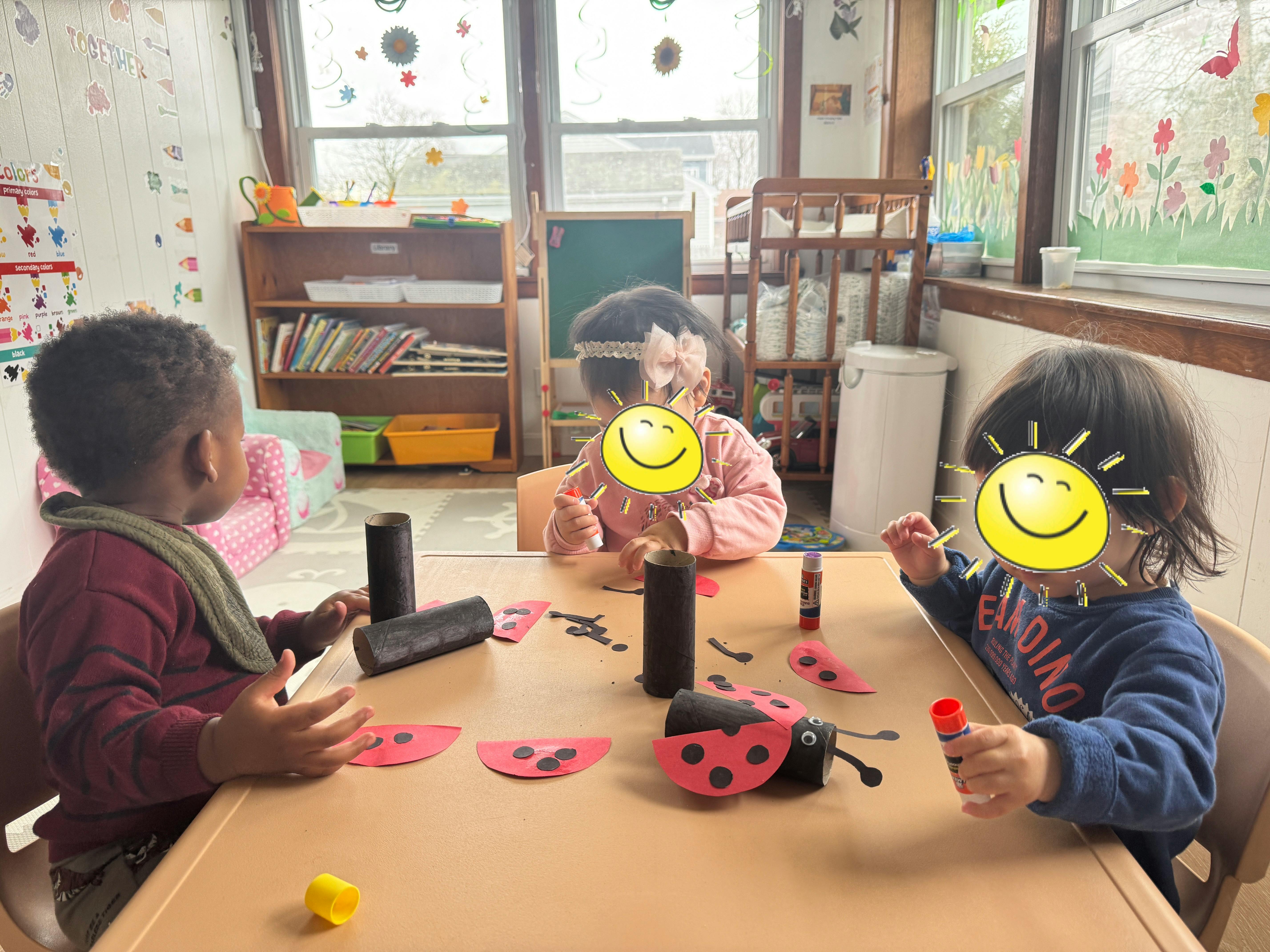 Three children at a table with craft supplies