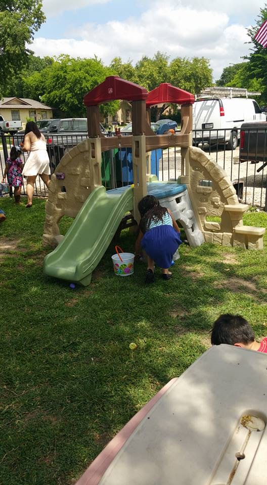 Child playing on a slide and play structure