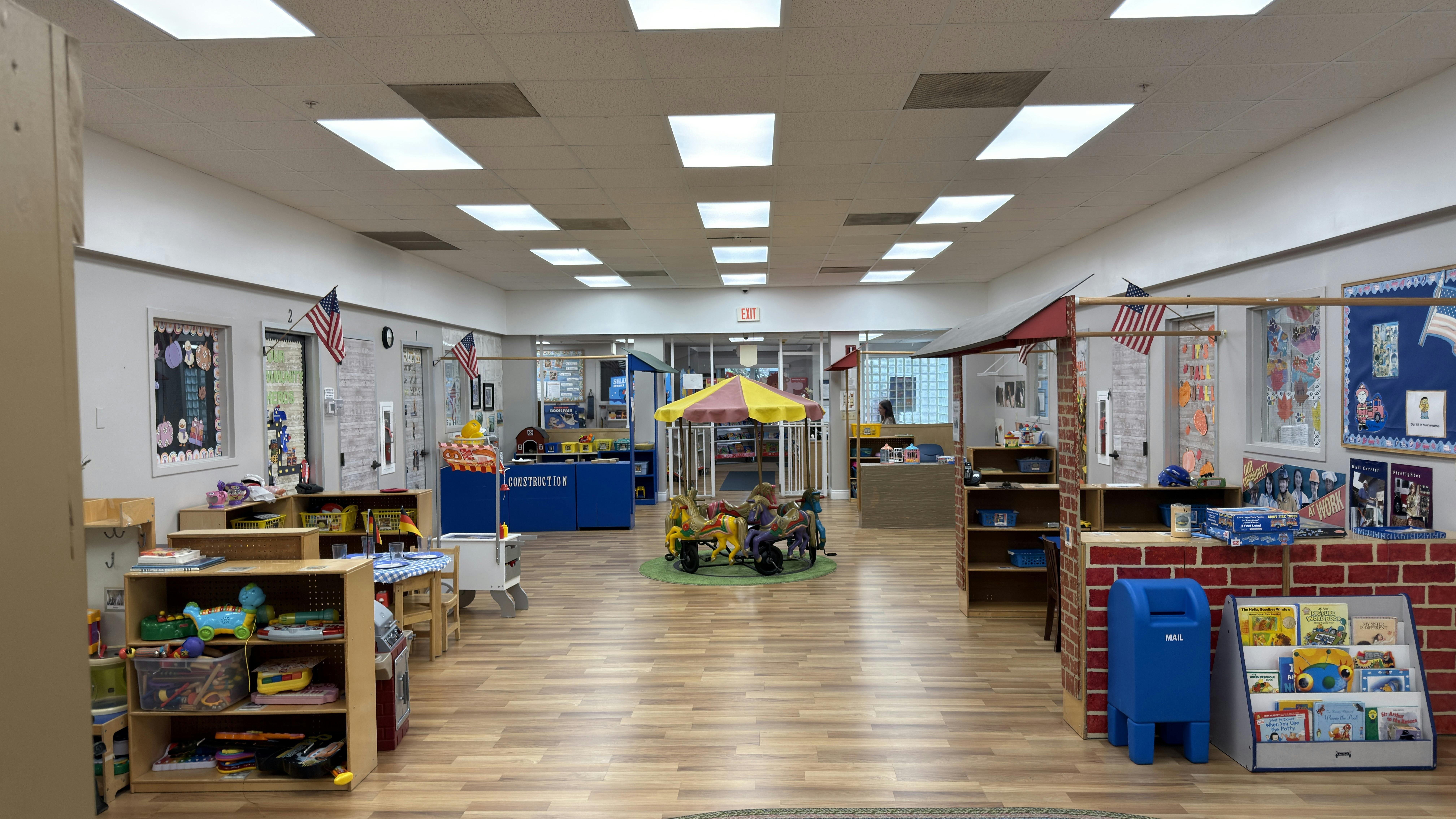 Classroom interior featuring play stations and a toy carousel