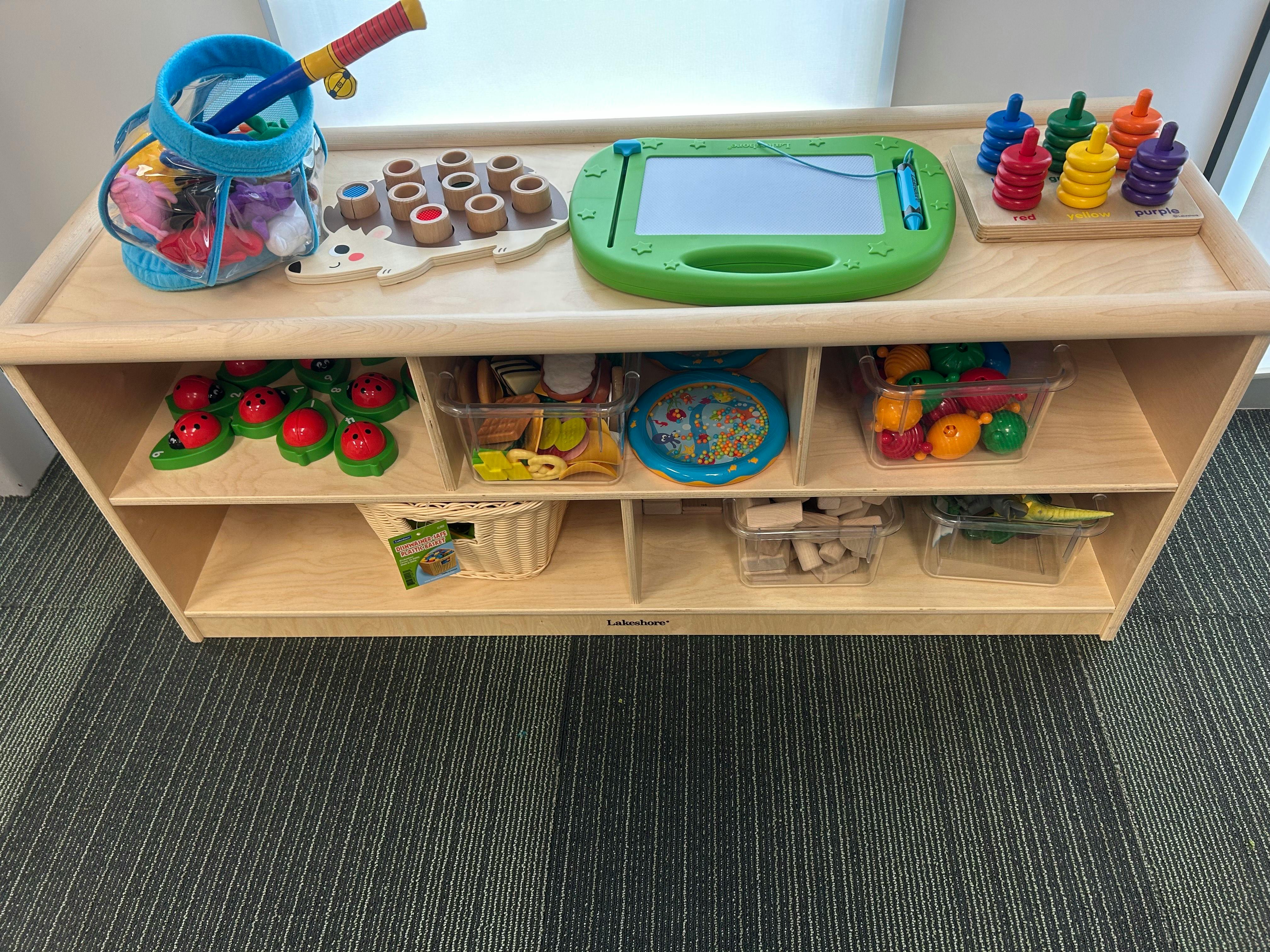 Wooden shelf with various colorful children's toys