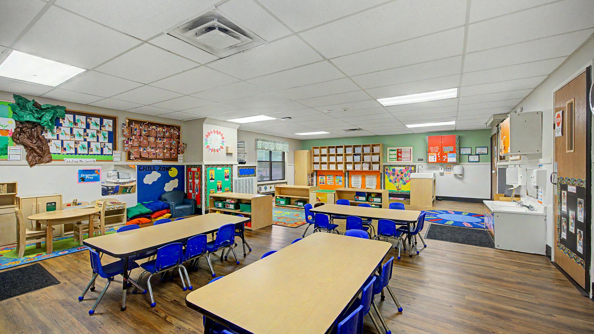 Classroom with child-sized tables, chairs, and activity areas