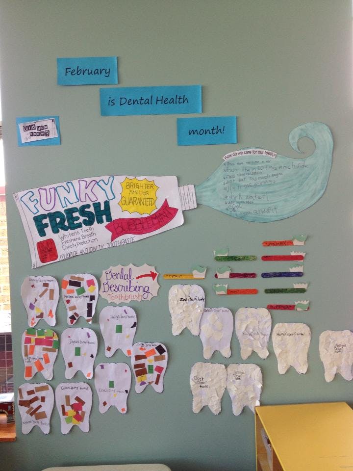 Dental health display with toothpaste, toothbrushes, and paper teeth