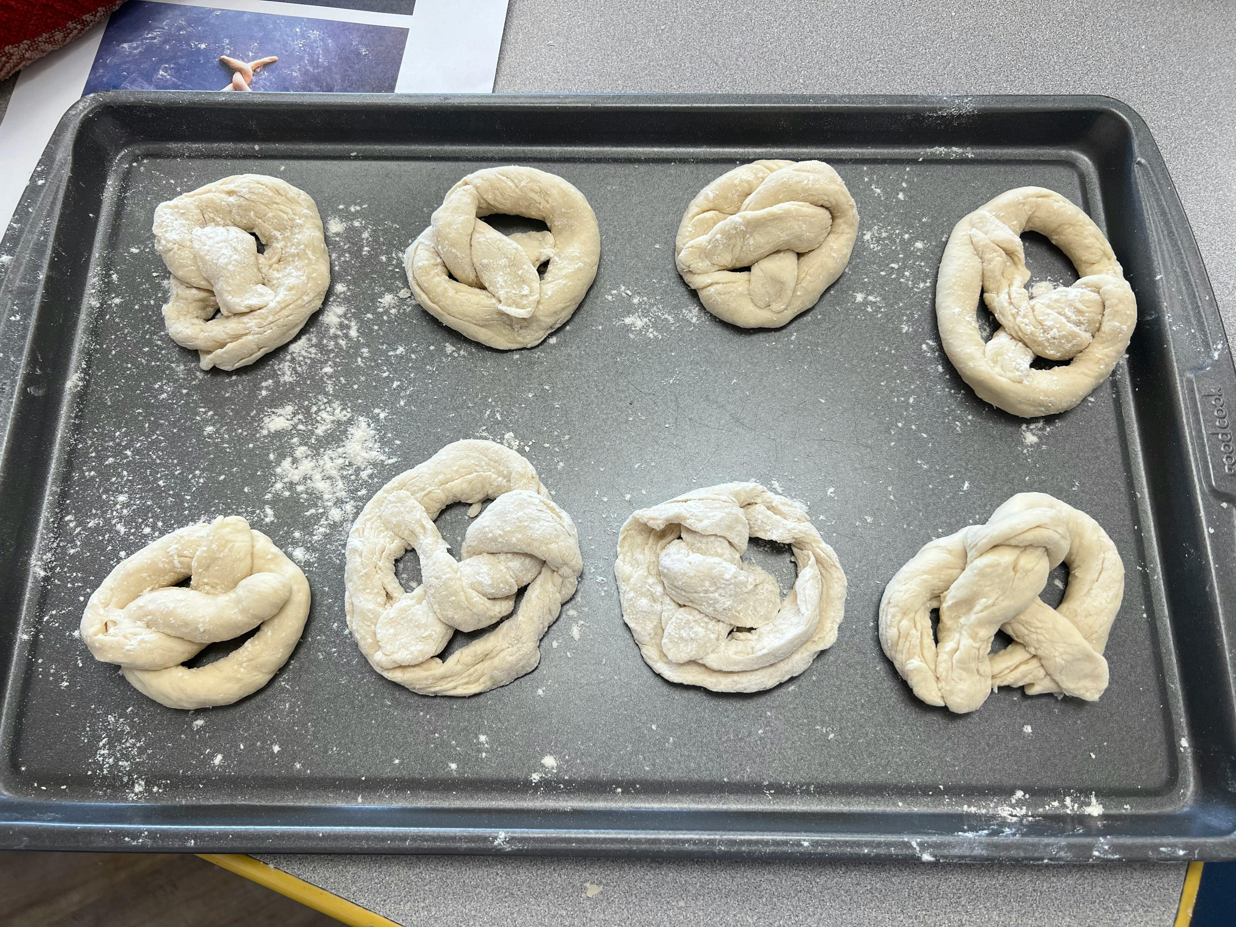 Unbaked pretzels on a baking sheet