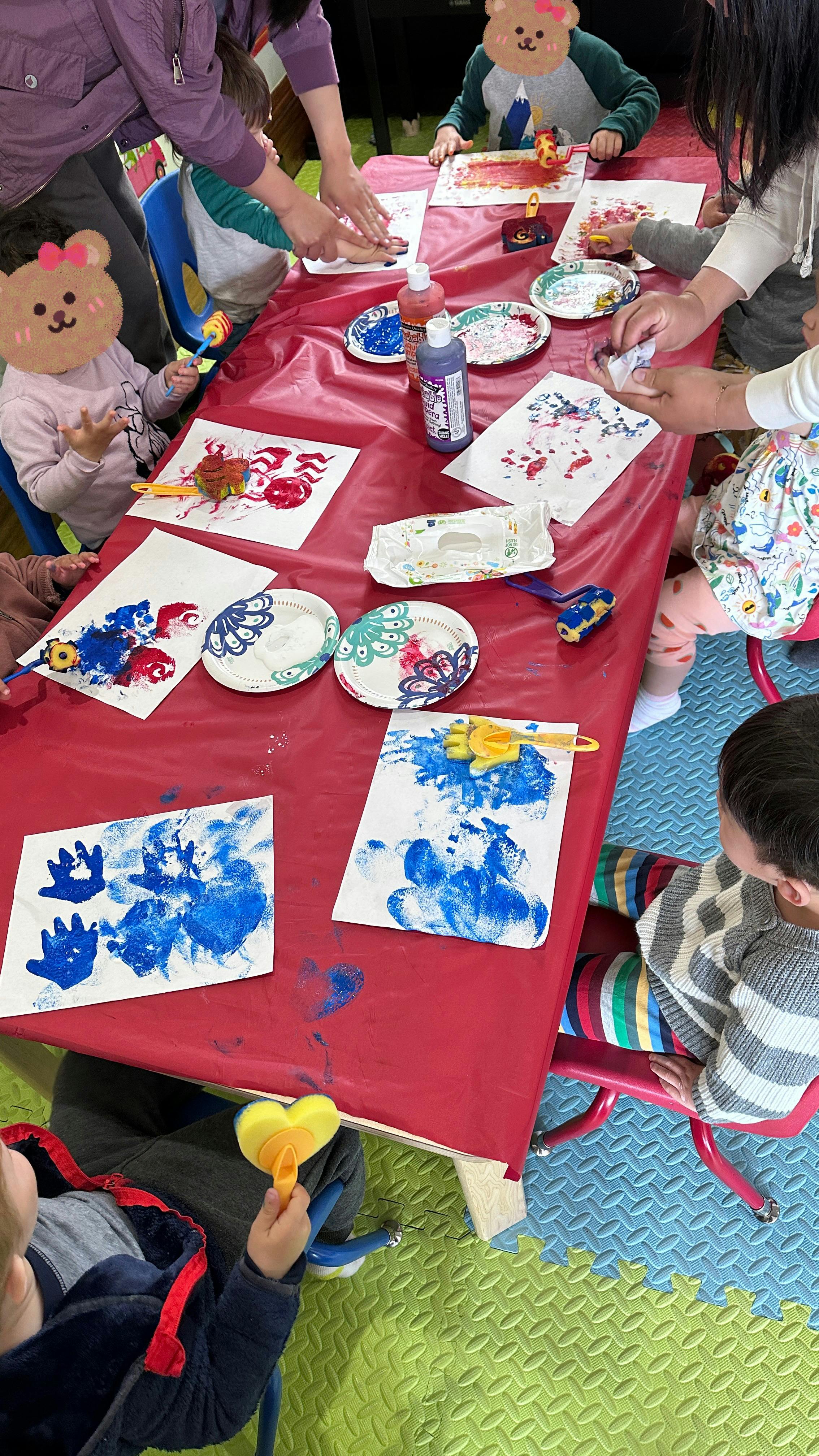 People and children painting at a table