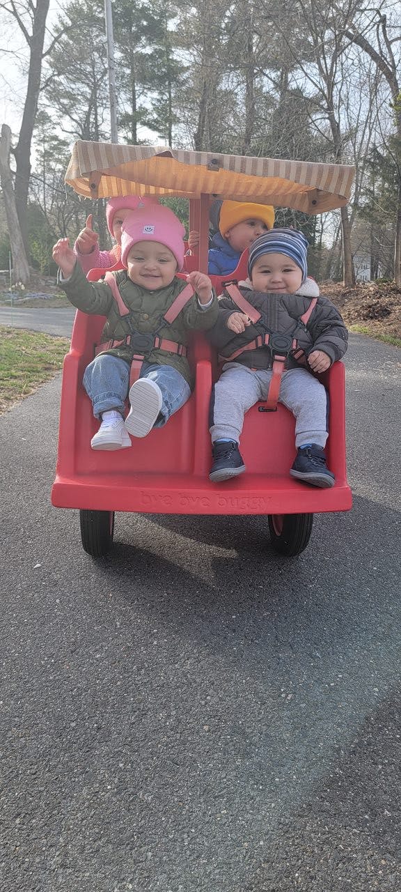 Three children in a red wagon