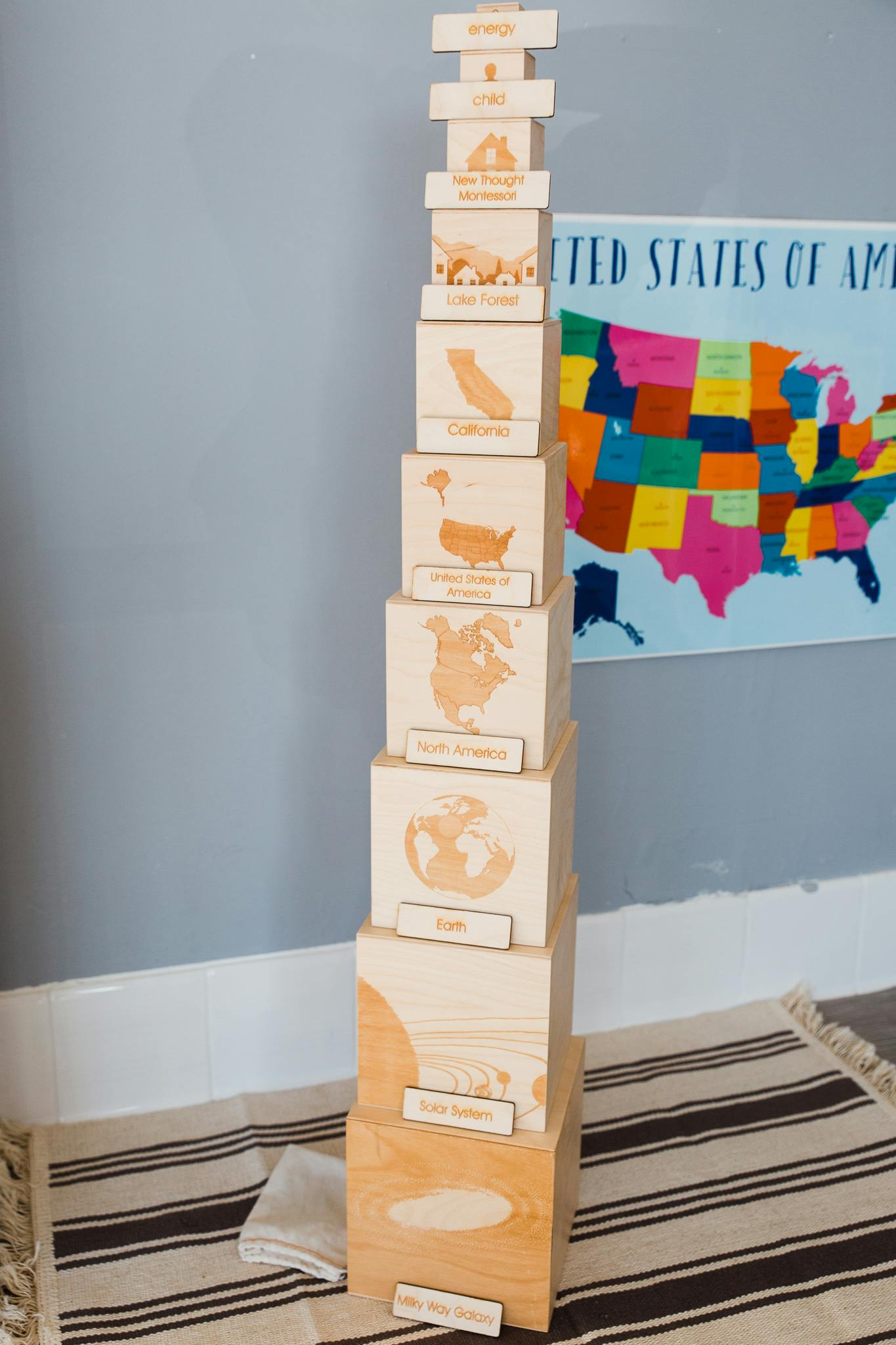 Stack of wooden blocks with maps and text, next to a colorful US map