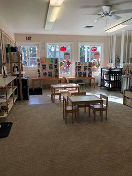 Empty classroom with small tables and chairs