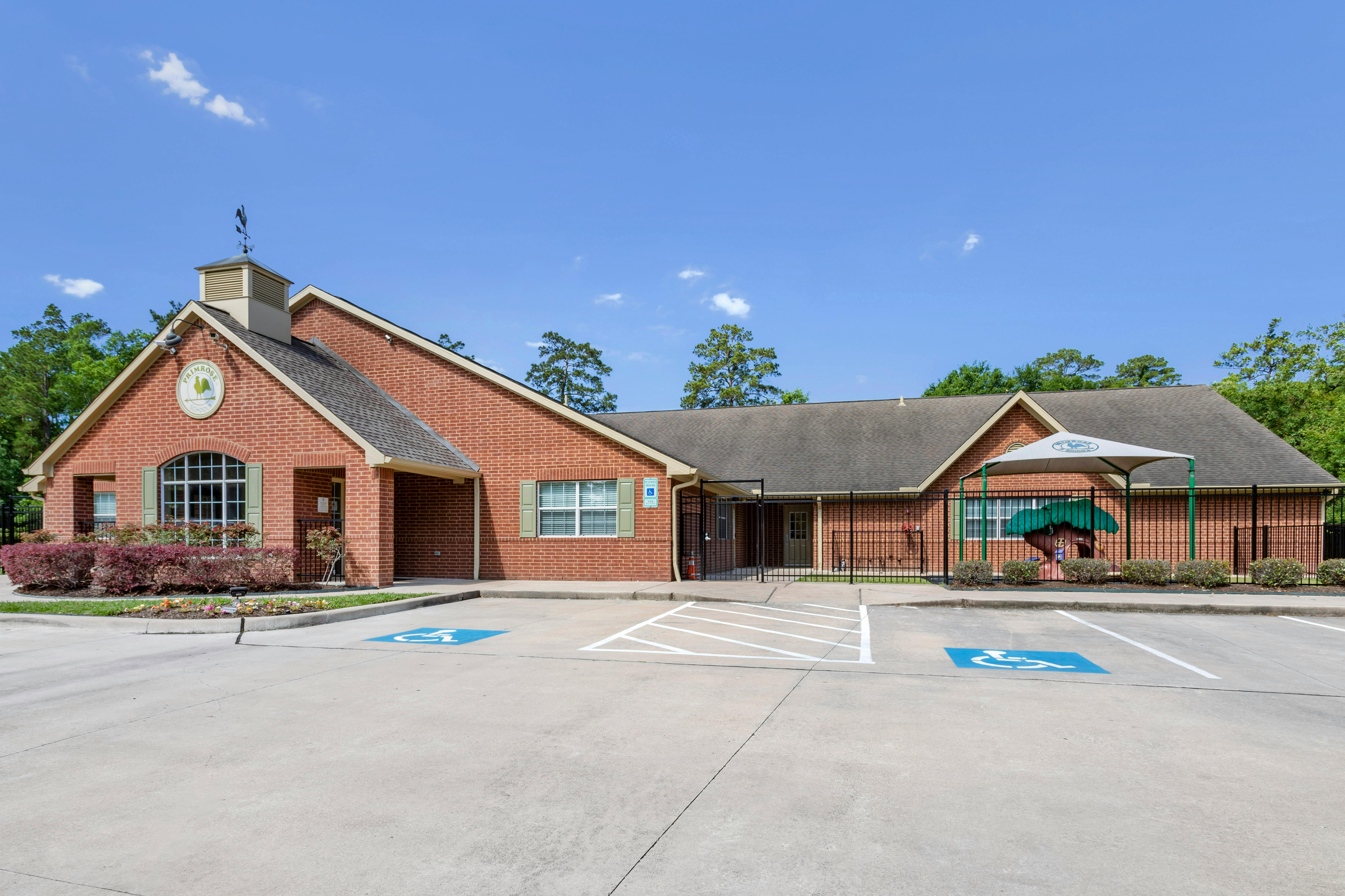 Brick building with a parking lot and a playground