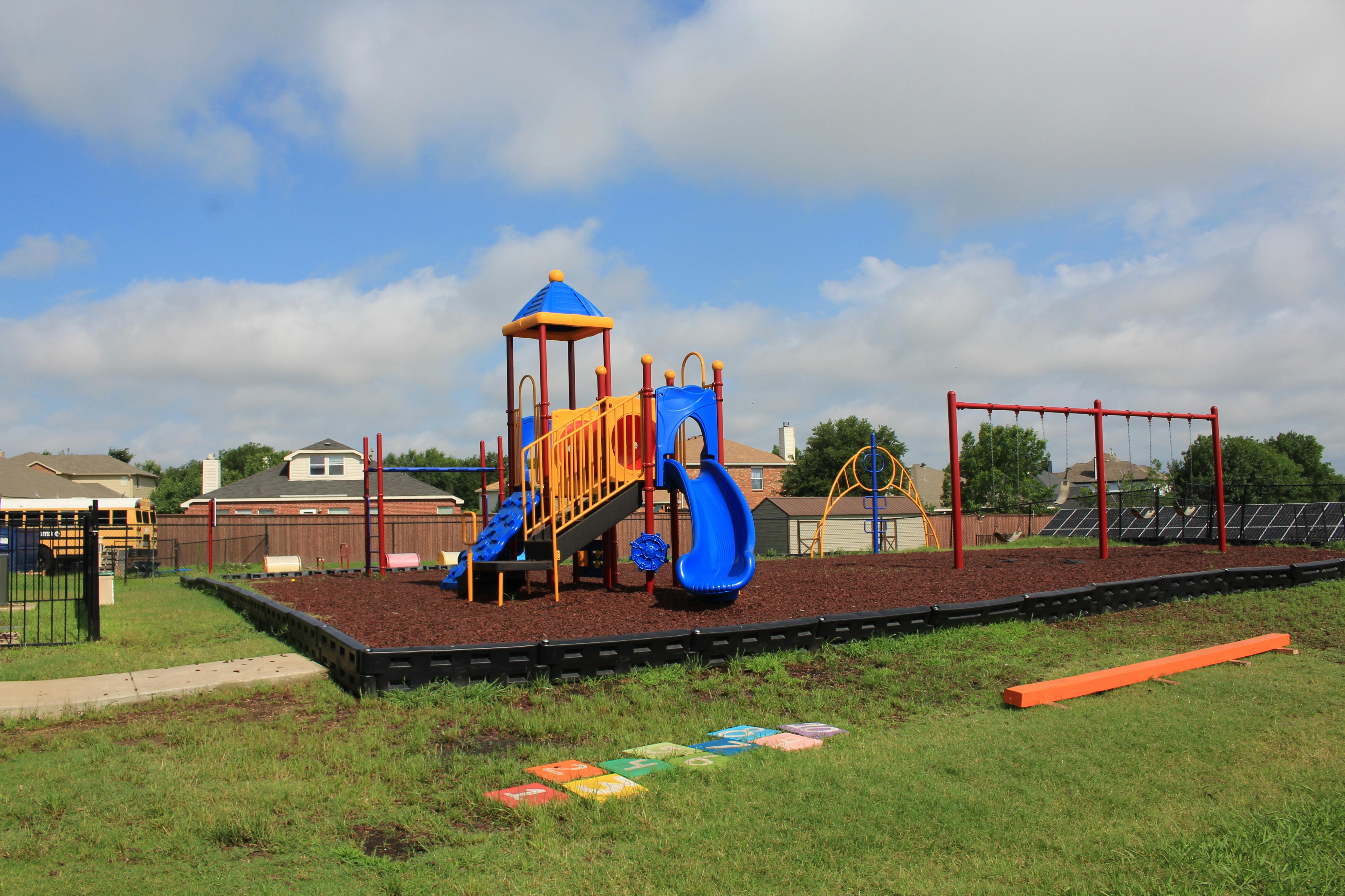 Playground with slides, swings, and climbing structures