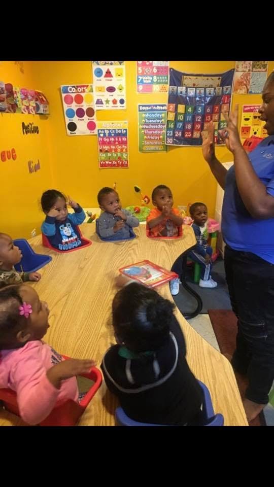 Person teaching a group of children in a classroom