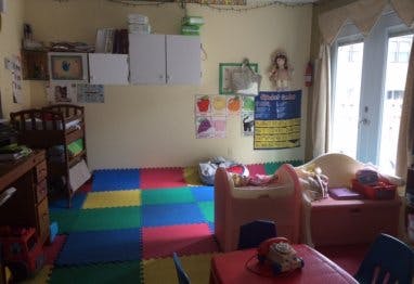 Child's play area with colorful floor mats and small furniture