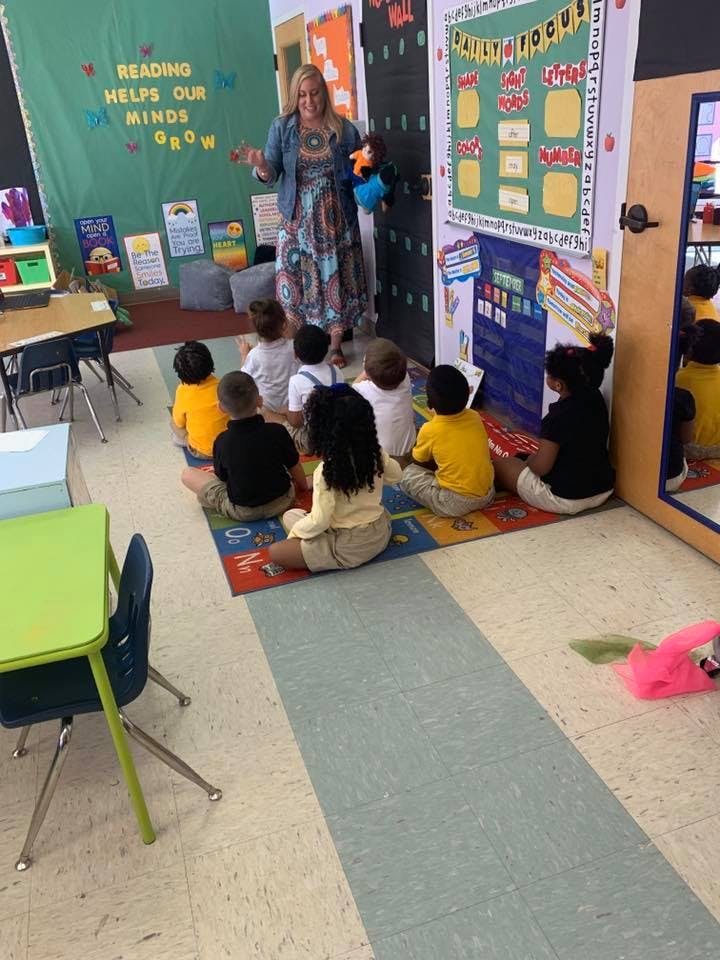Adult teaching children in a classroom