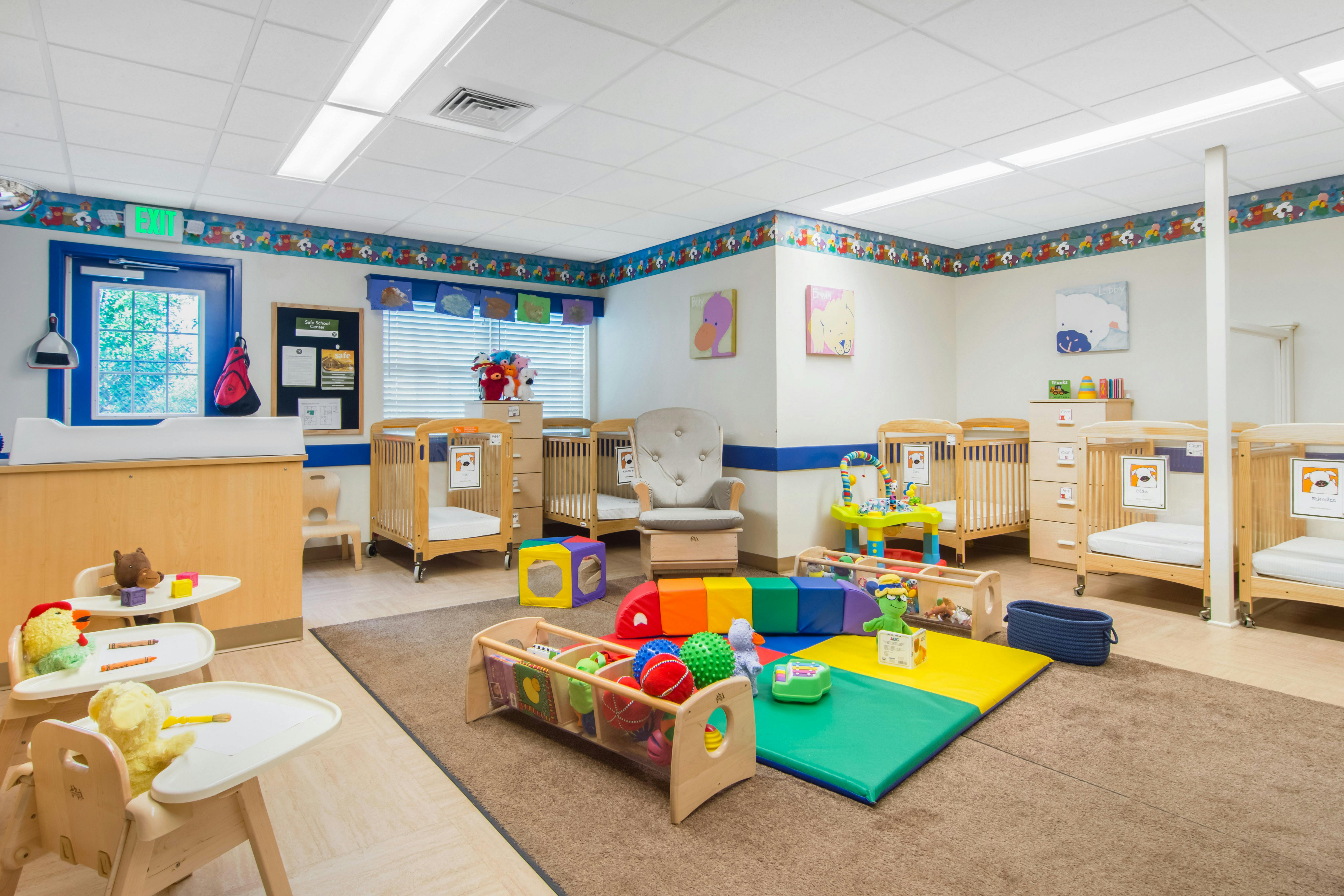 Baby room with multiple cribs, a changing station, and toys