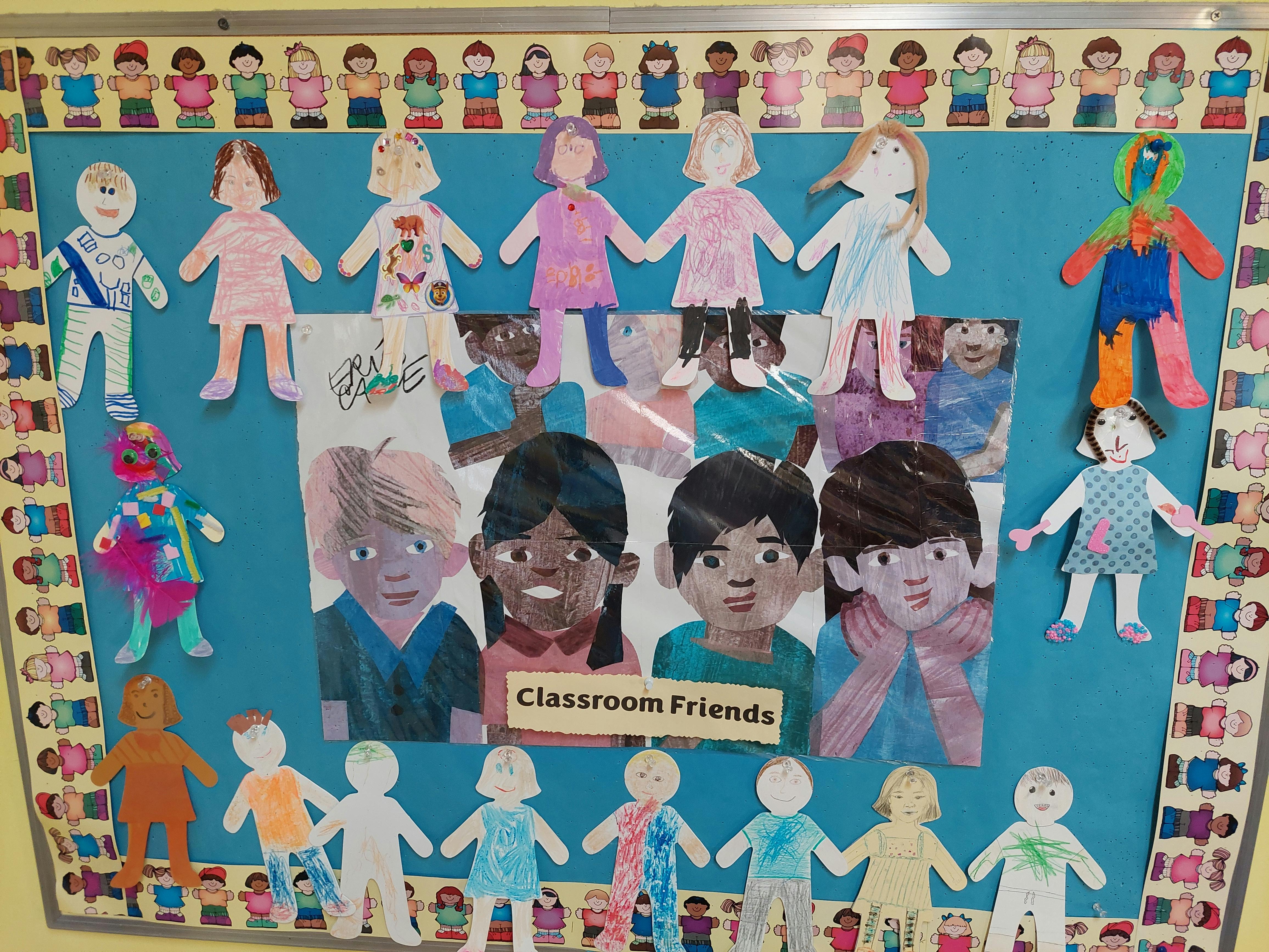 Classroom bulletin board with paper cutouts of people and text that says "Classroom Friends"