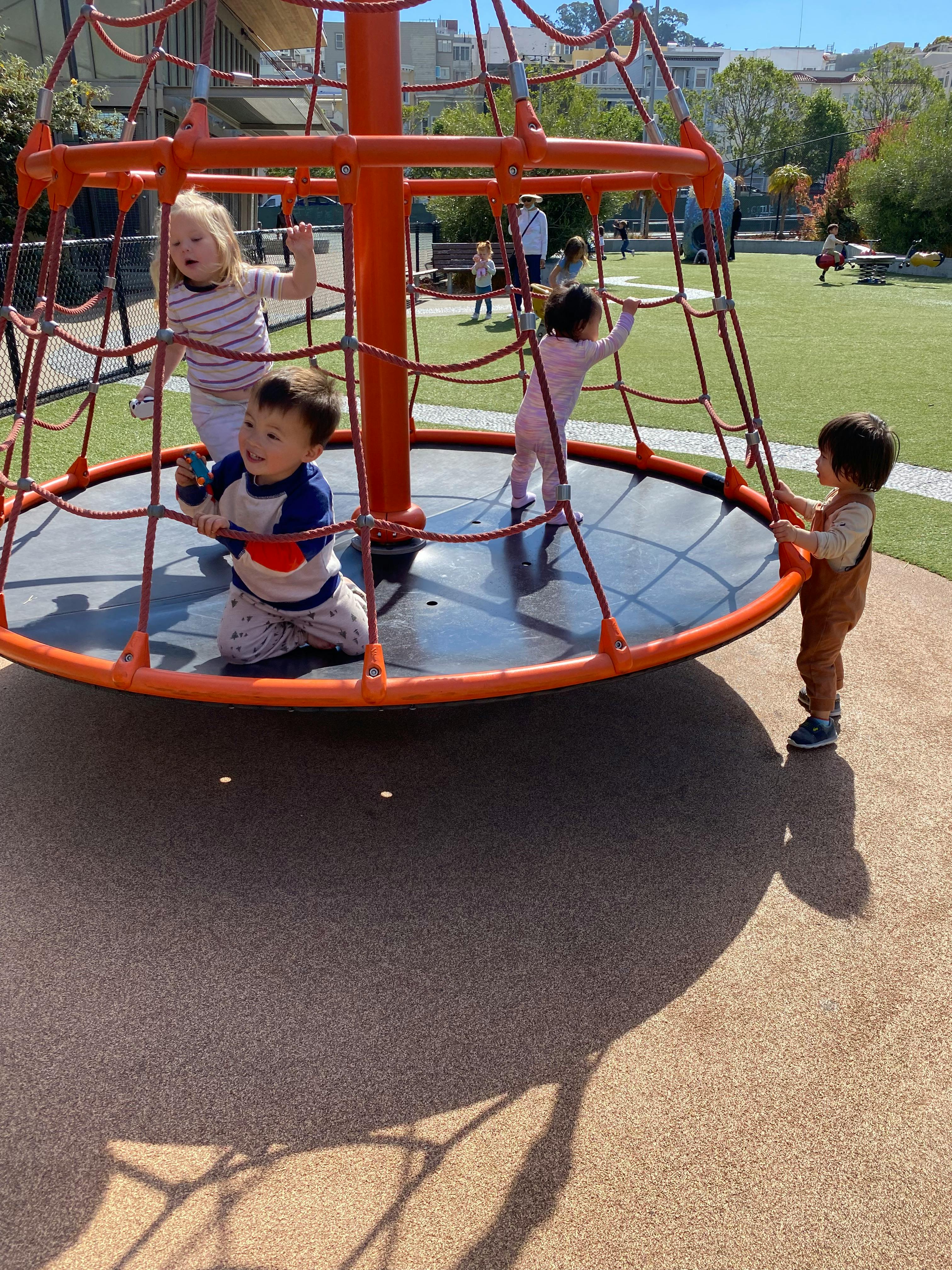 Children playing on a playground climbing structure