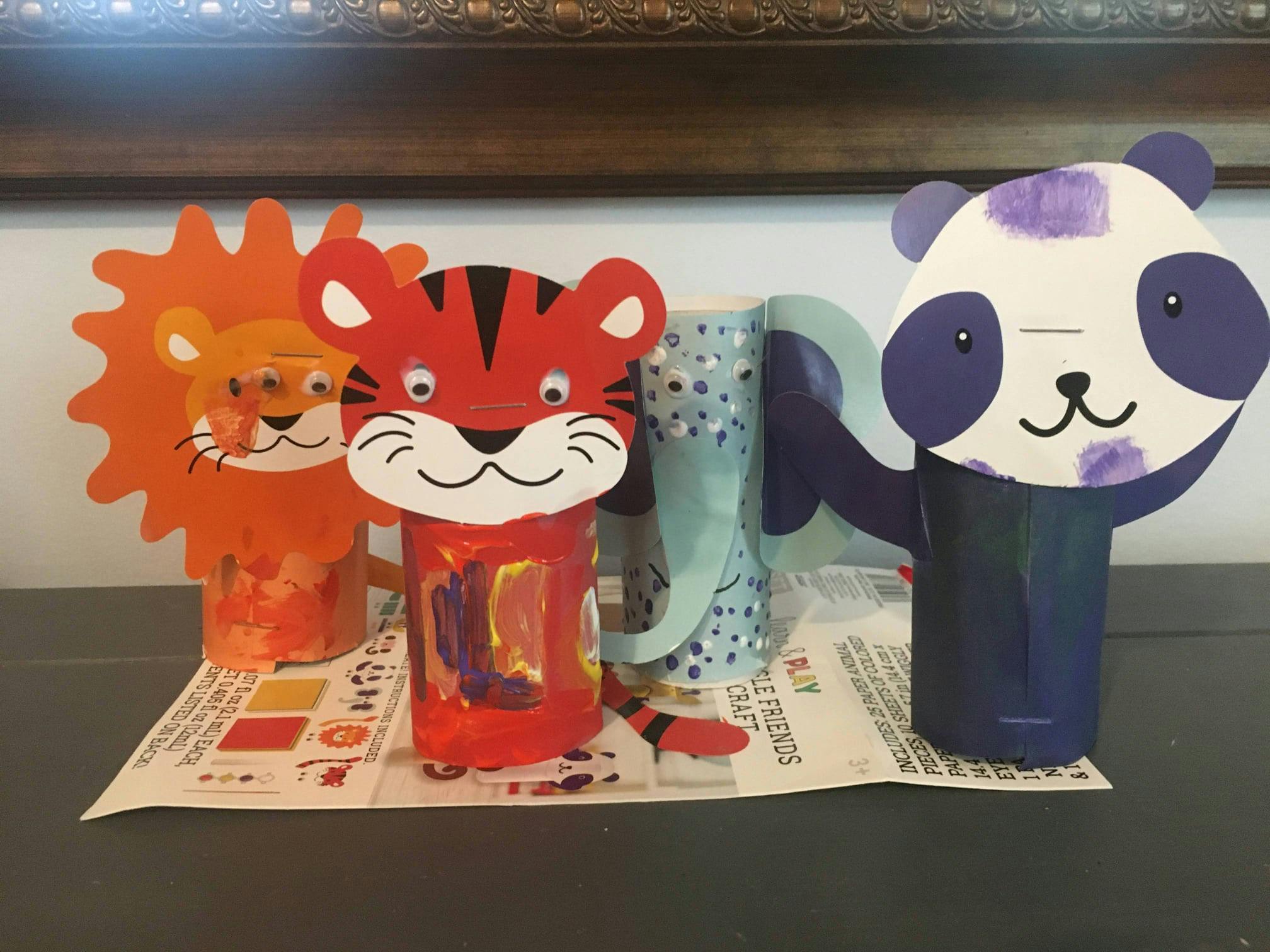 Crafts of a tiger, lion, and panda made from paper and painted rolls
