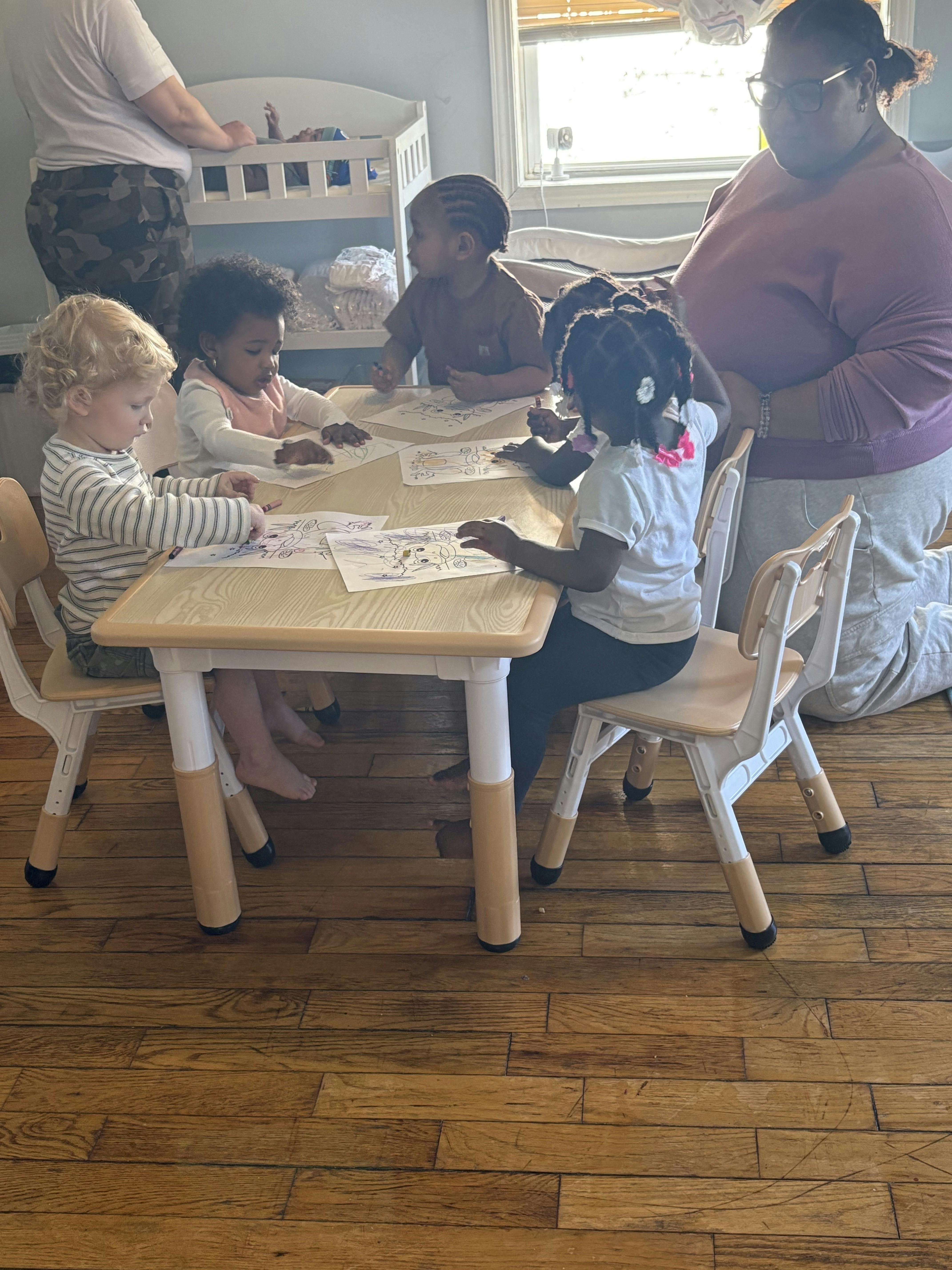 Group of children coloring at a small table