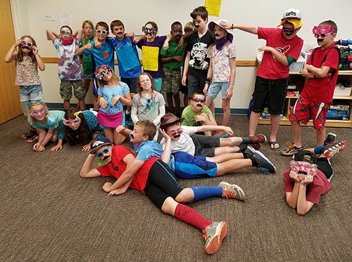 Group of children and teens posing with novelty glasses and mustaches