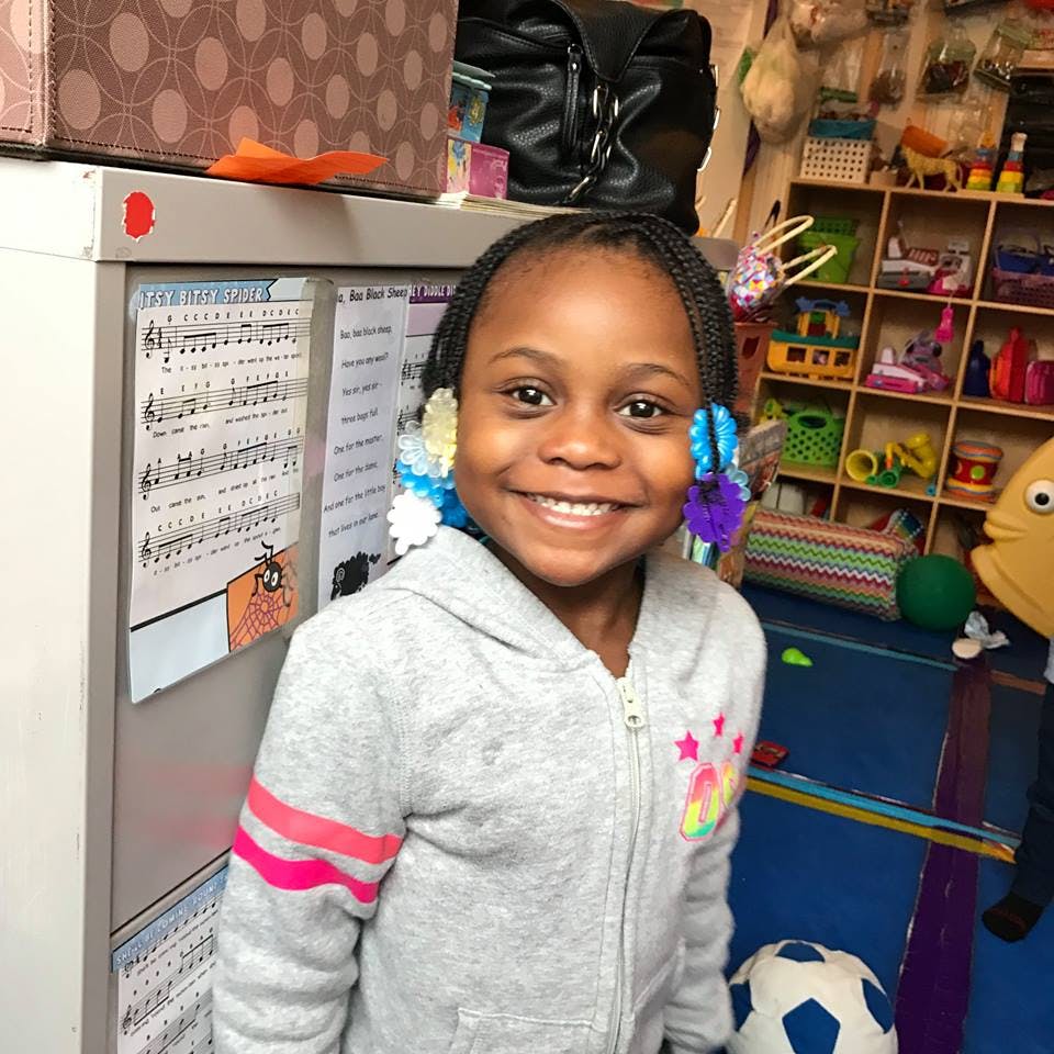 Child smiling in a classroom
