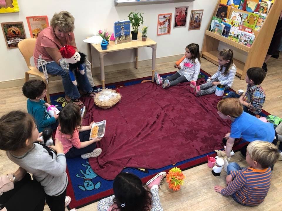 Person reading to children in a classroom
