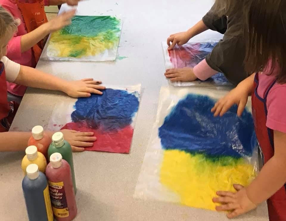 Children doing a paint bag art activity
