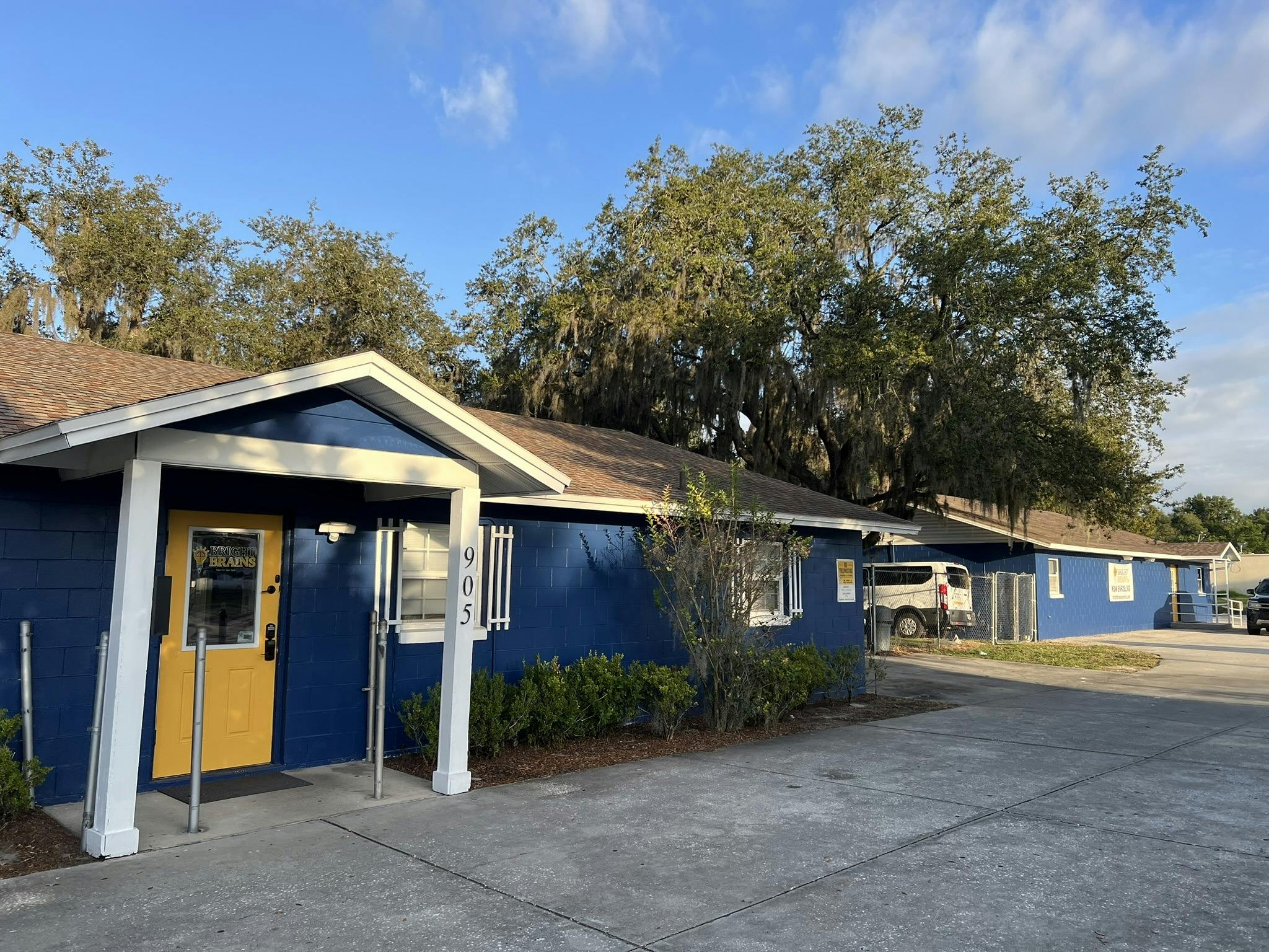 Blue building with a yellow door and white trim