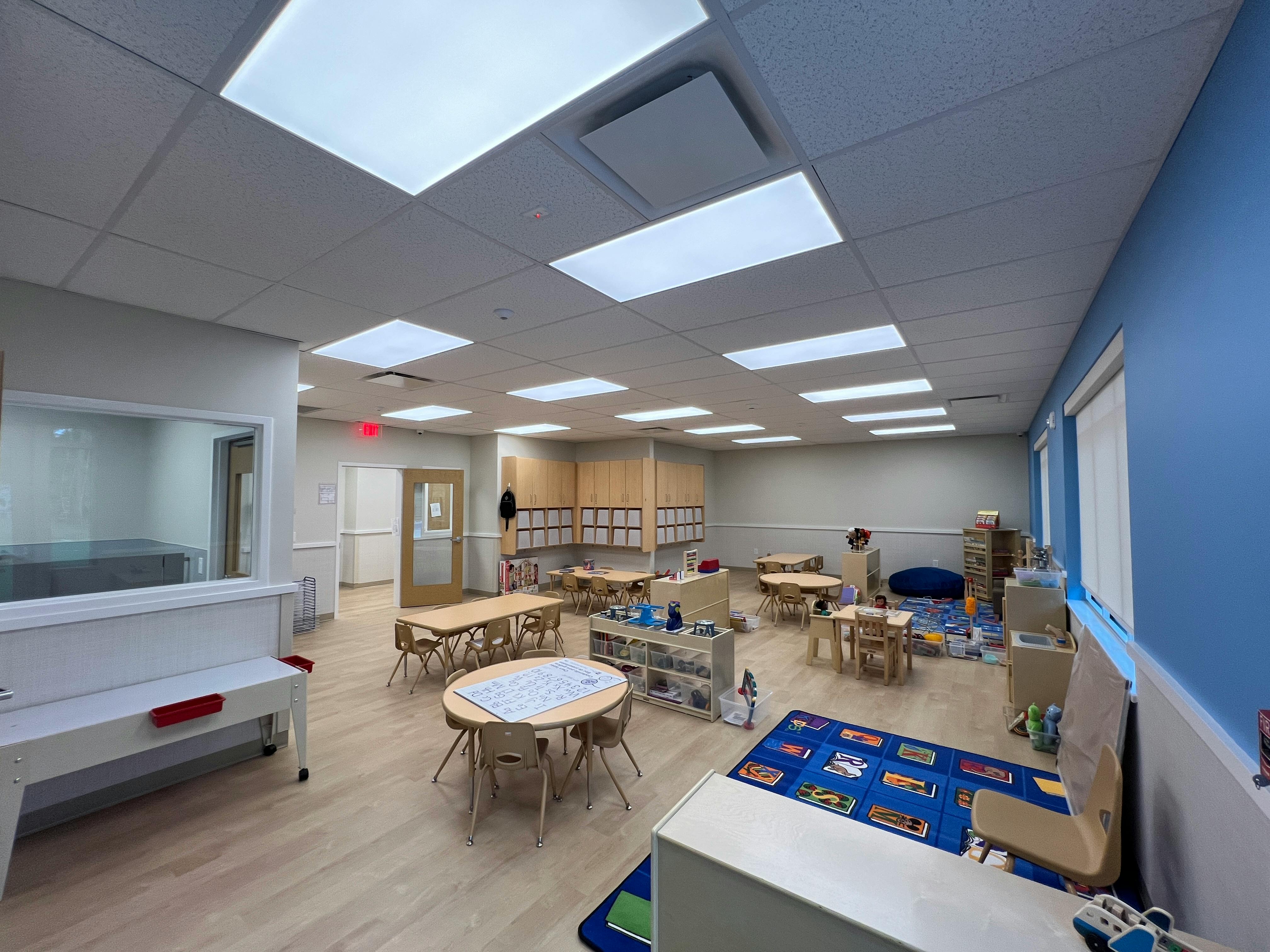 Empty classroom with small tables and chairs