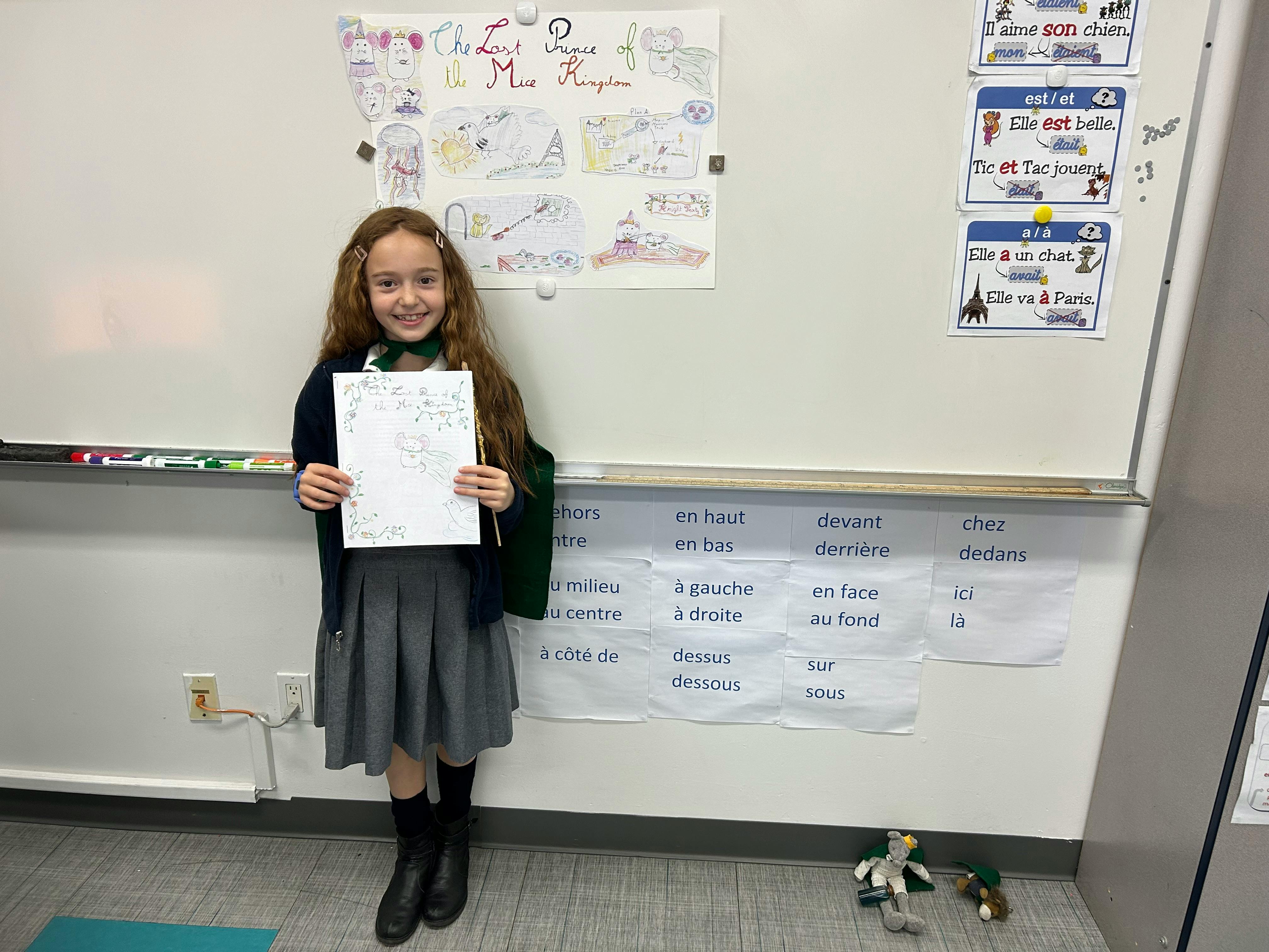 Child holding up a piece of paper in a classroom