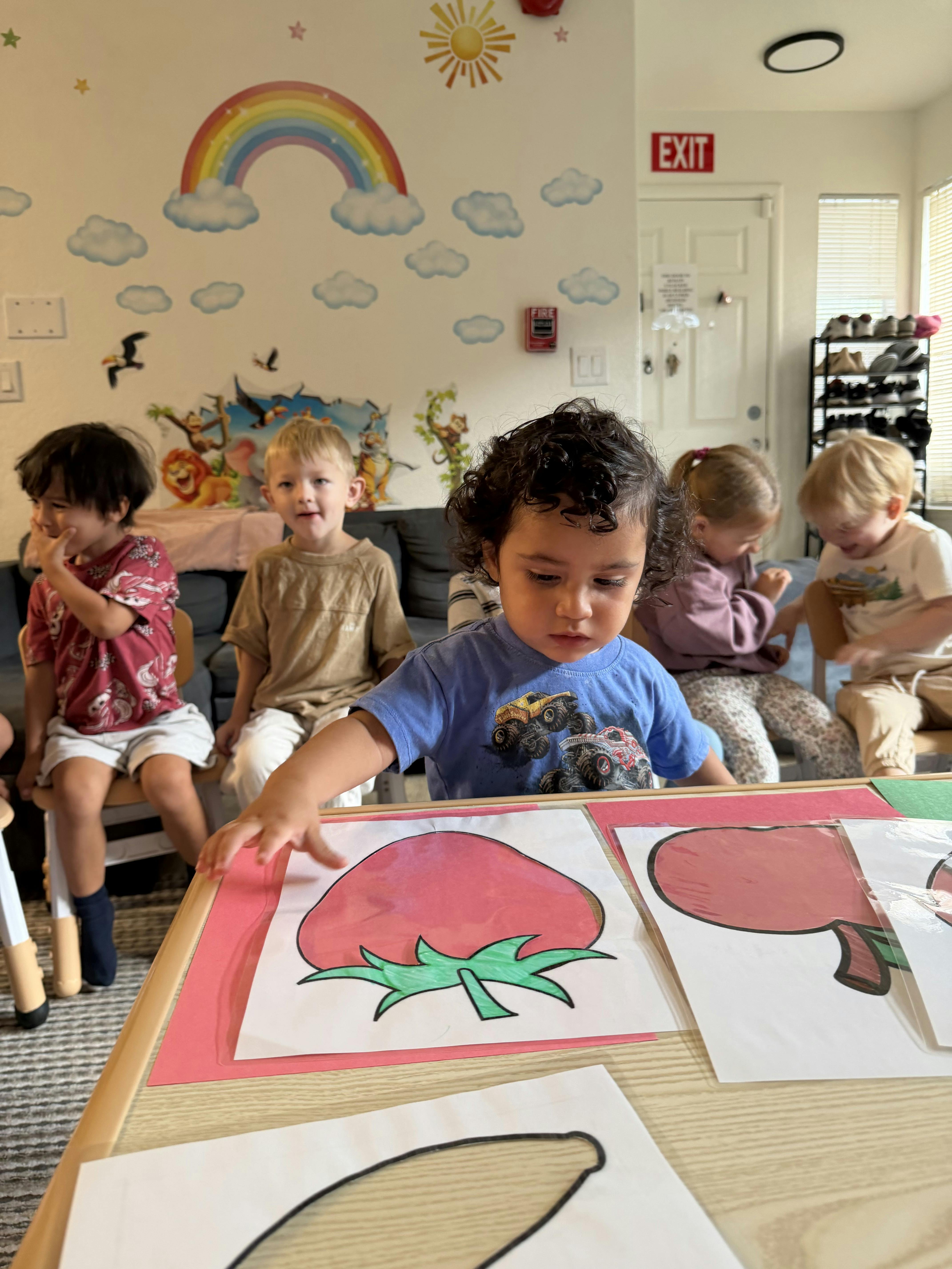 Children working on art projects at a table in a classroom