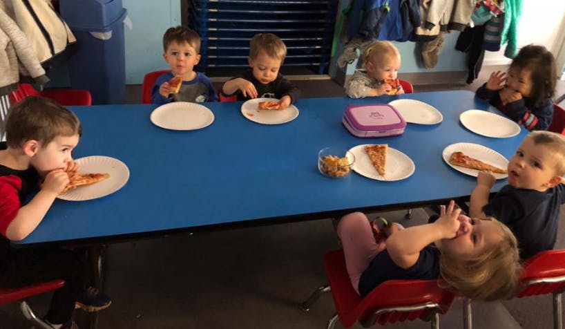 Children eating pizza at a table