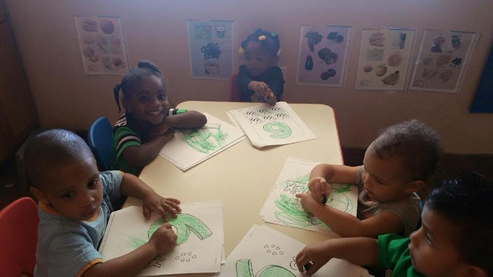 Children coloring at a table