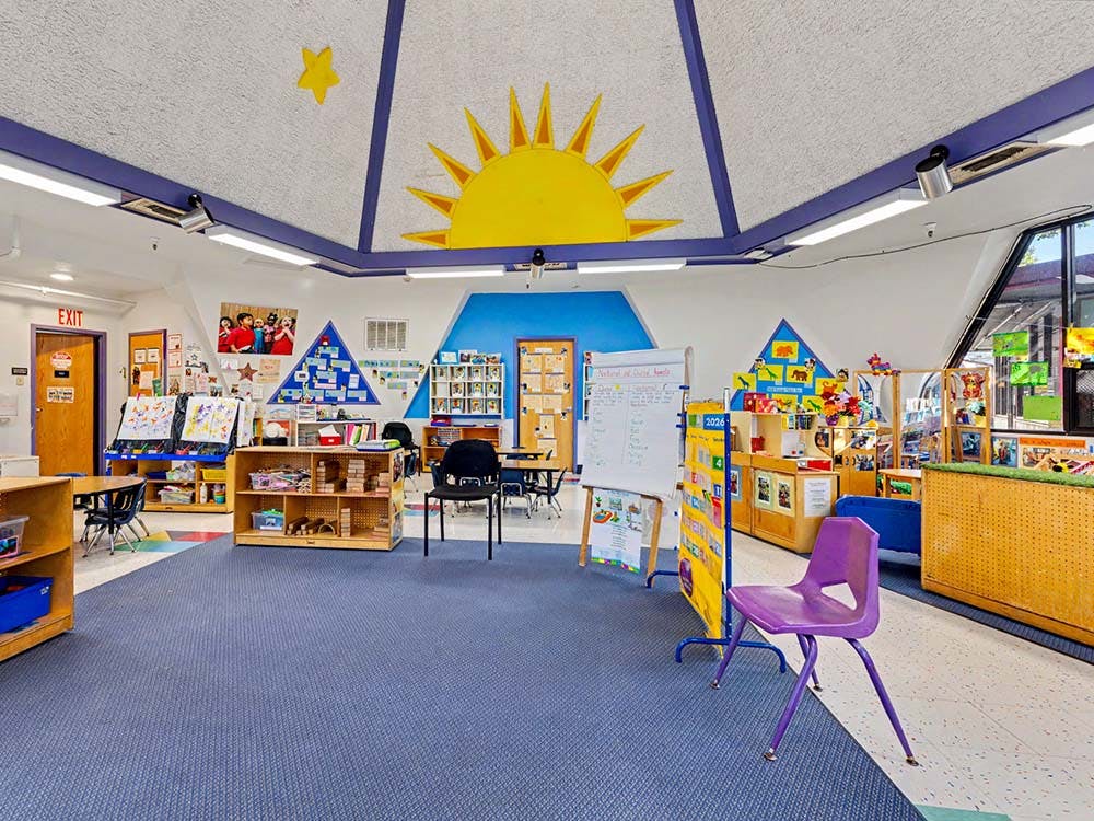 Empty colorful preschool classroom with a sun and star on the ceiling