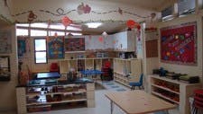 Classroom with shelves, tables, and decorations