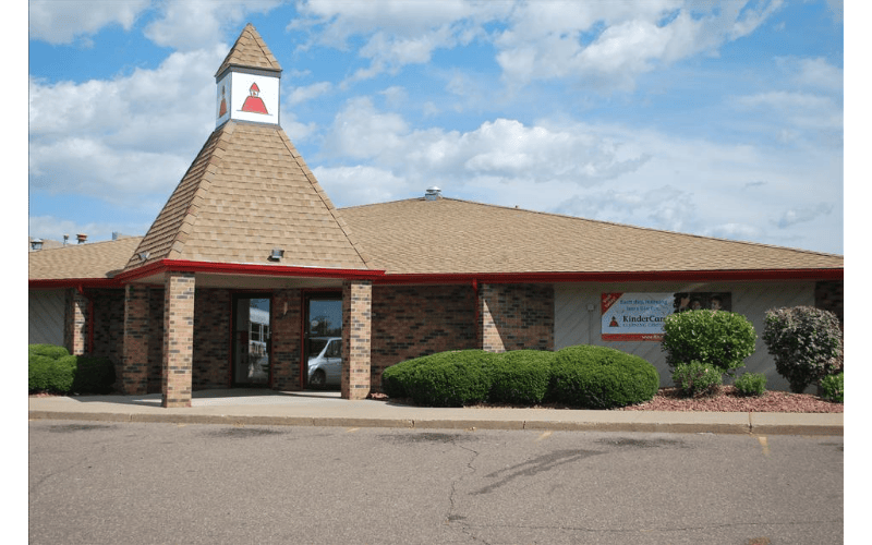 Brick building with a brown roof and a small steeple