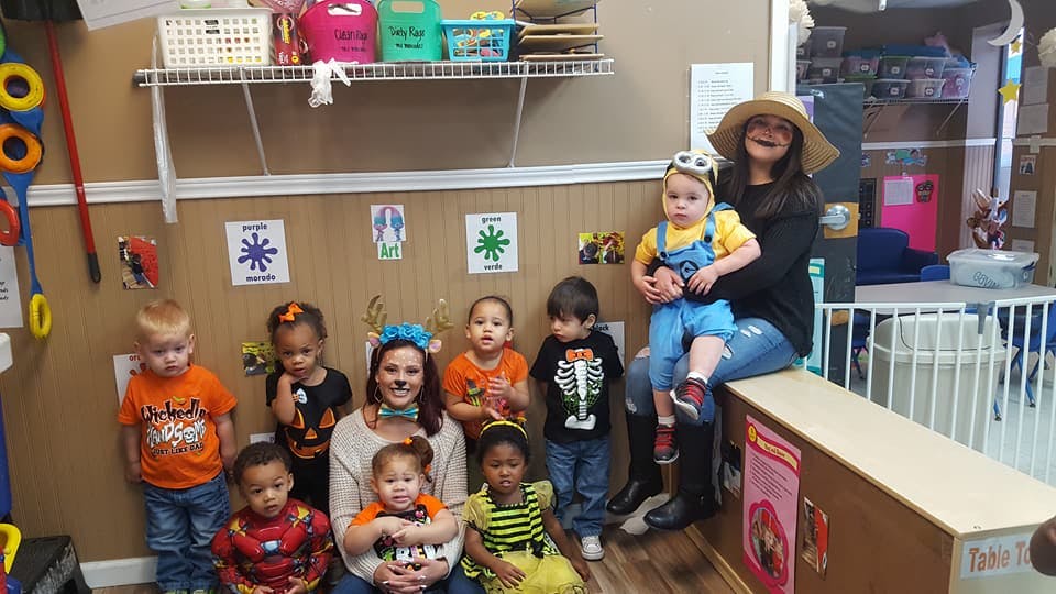 Adults and children in costumes in a room