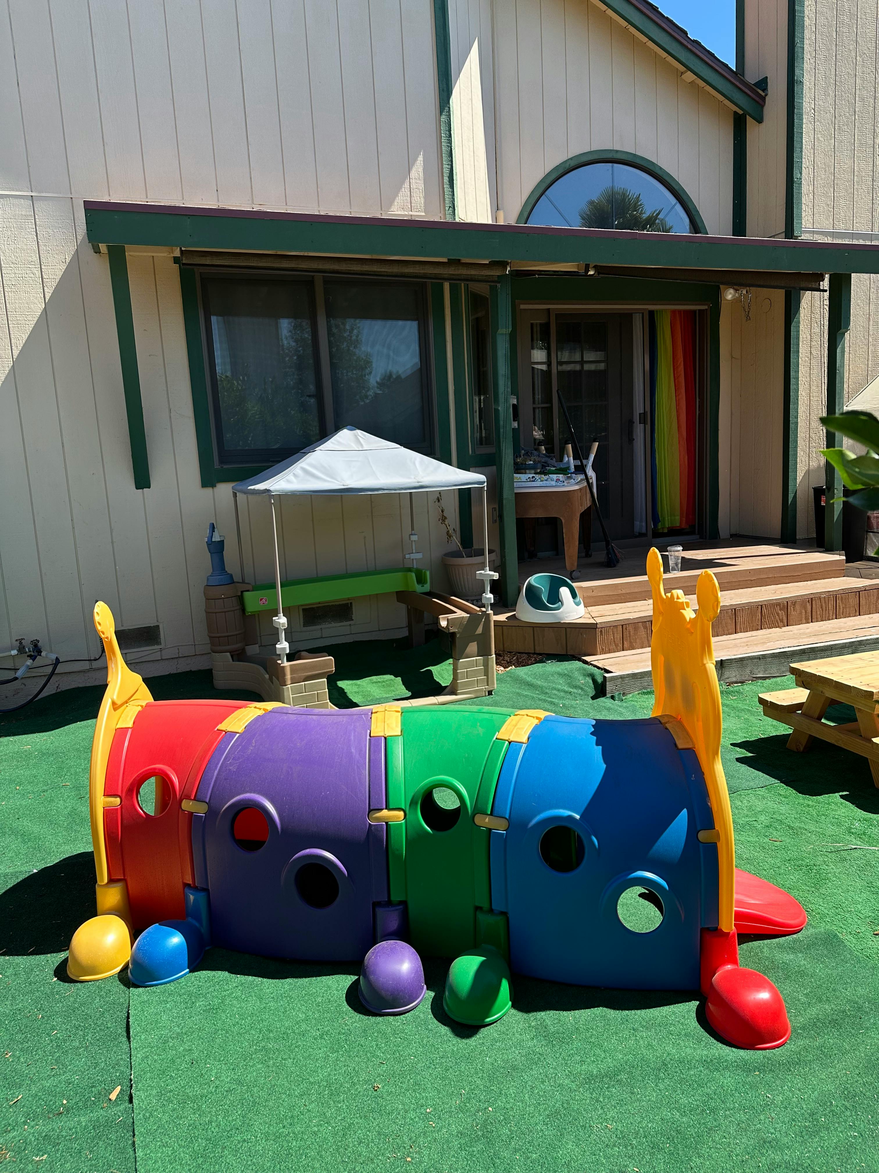 Colorful plastic play tunnel on green turf