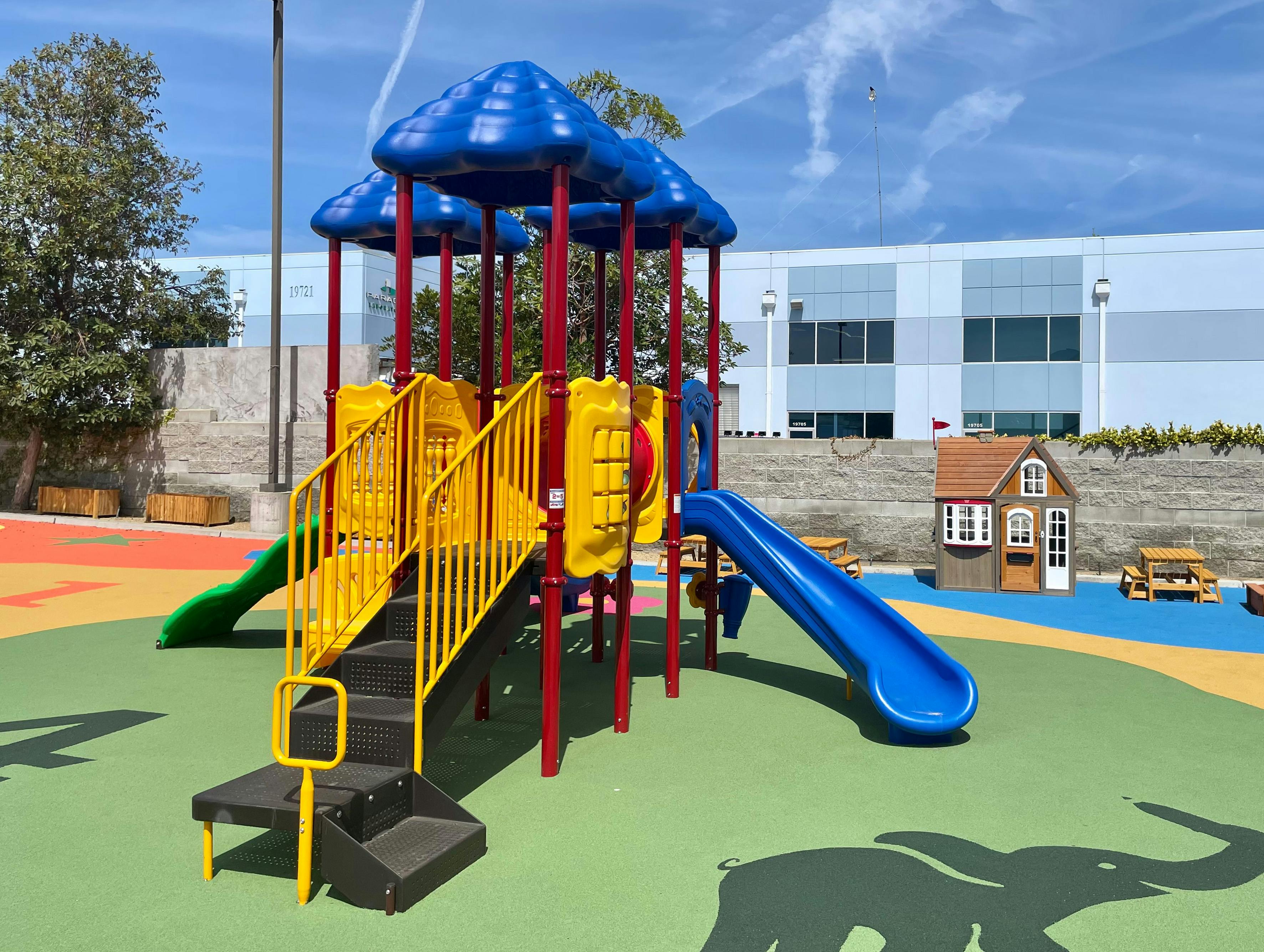 Playground with blue slides and yellow stairs