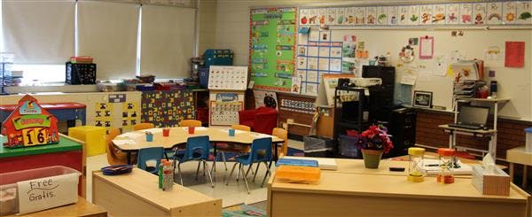 Empty classroom with small tables and chairs