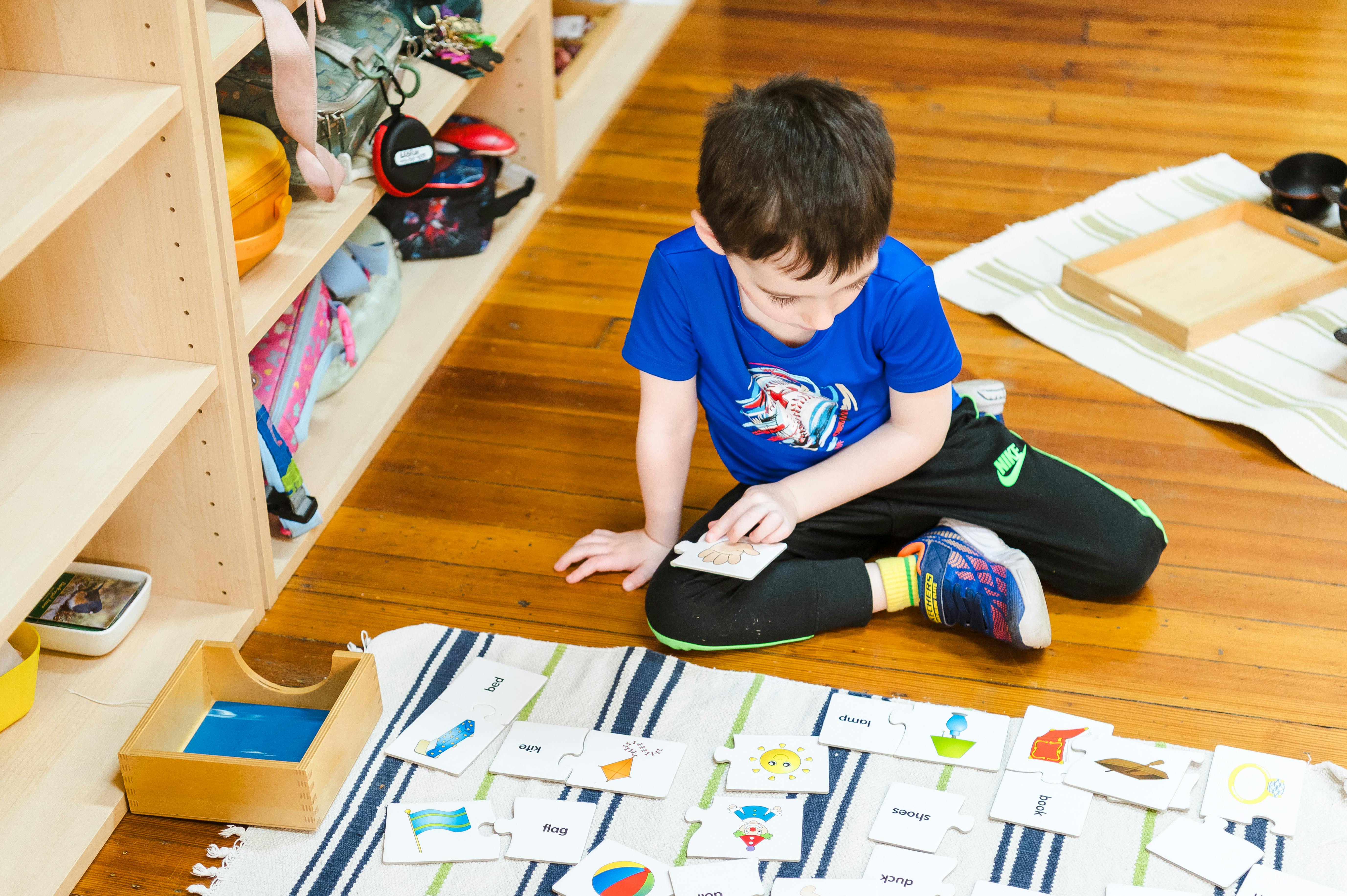 Child sitting on floor looking at cards